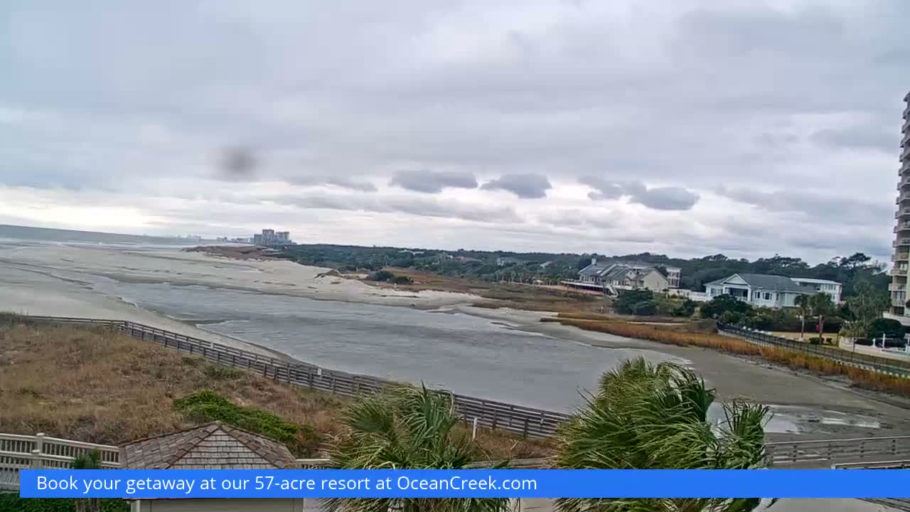 The image displays a very dark and grainy outdoor scene at night, with a vague horizon line separating a dark, indistinct foreground from an equally dark sky, and a faint rectangular light visible on the far right.