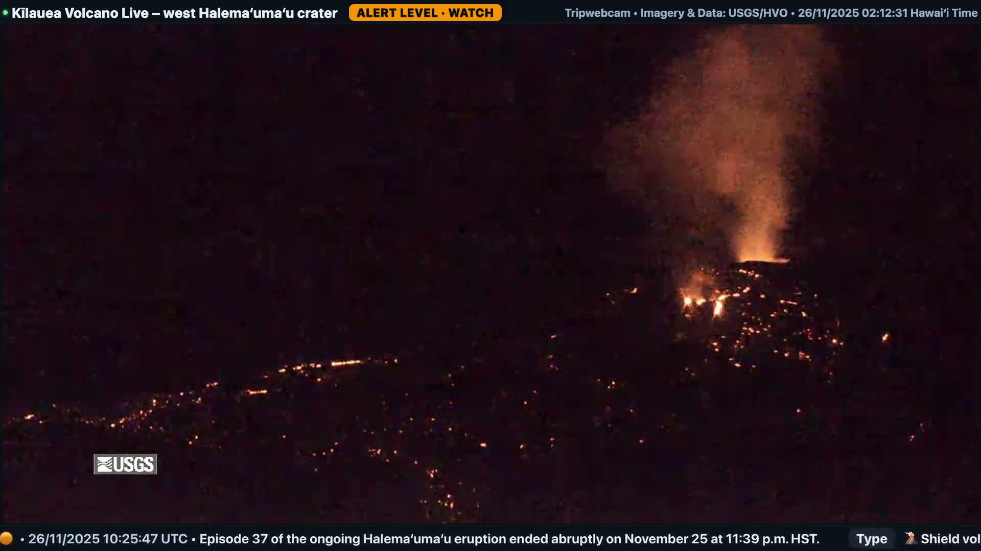 Under a clear night sky, molten orange lava flows snake across dark volcanic slopes, illuminated by the fiery eruption and rising plumes of smoke.