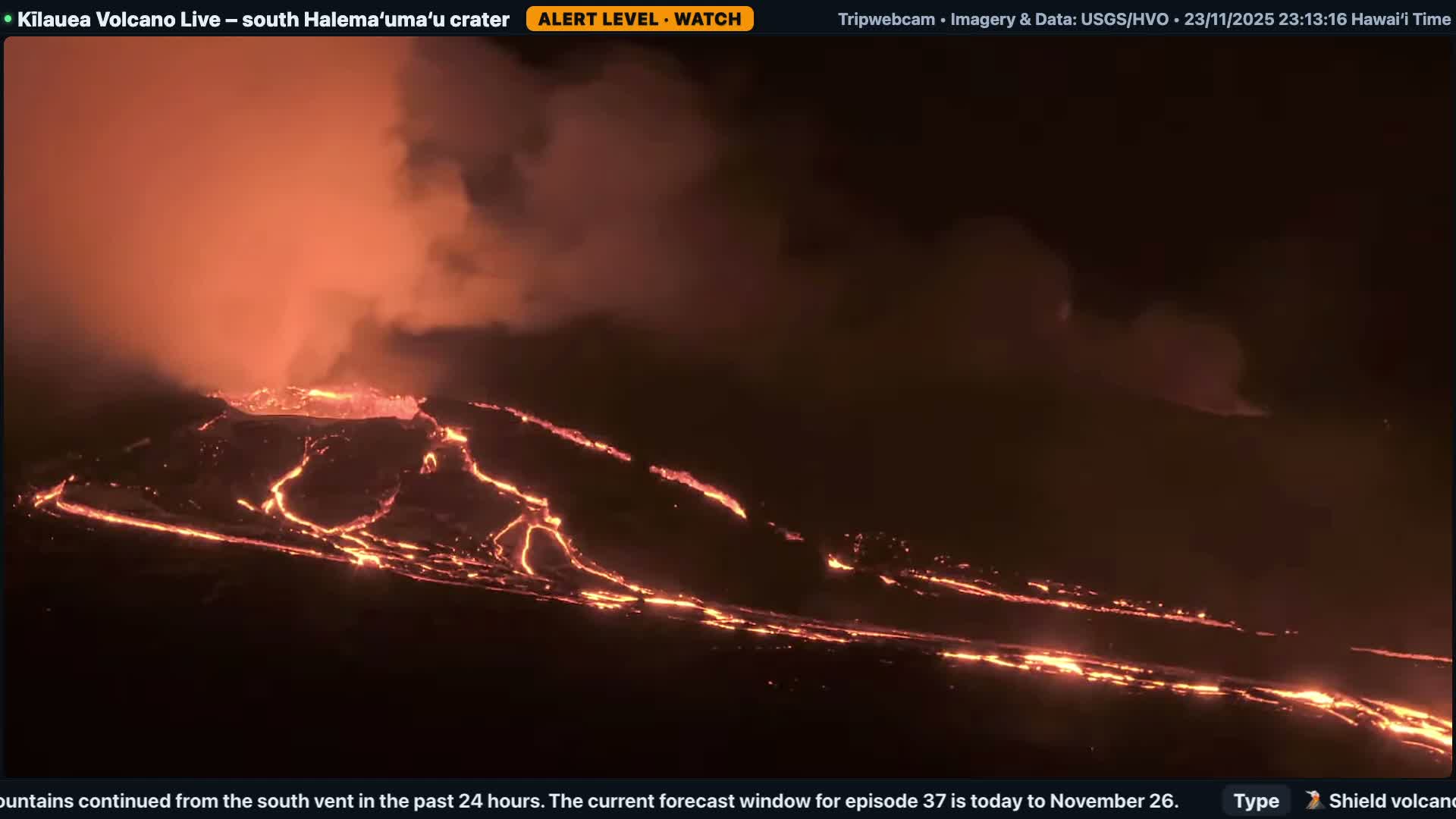 The image depicts a powerful nighttime volcanic eruption with a central vent spewing bright orange lava and a plume of reddish smoke into a dark, hazy sky, while glowing rivers of molten rock flow across the dark, uneven landscape.
