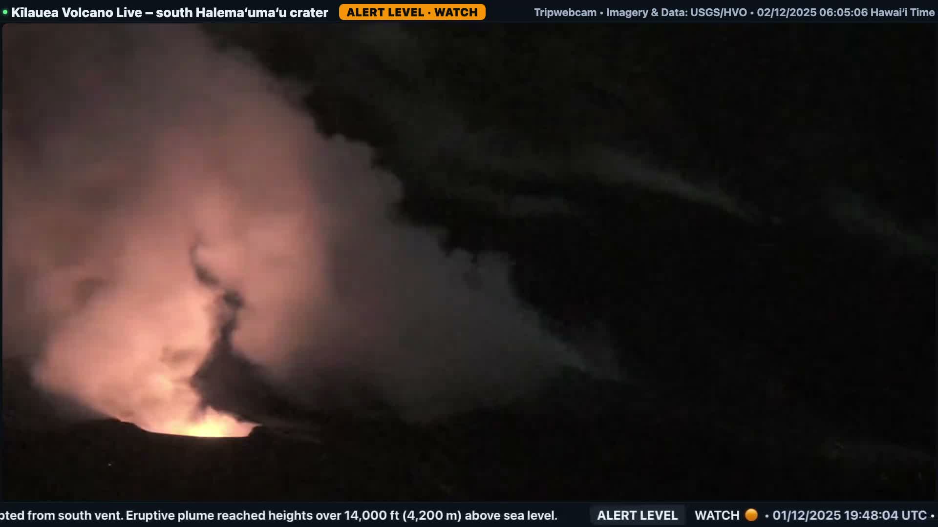 At night, a volcano actively erupts, spewing a large, glowing orange plume of smoke and ash into the dark sky.