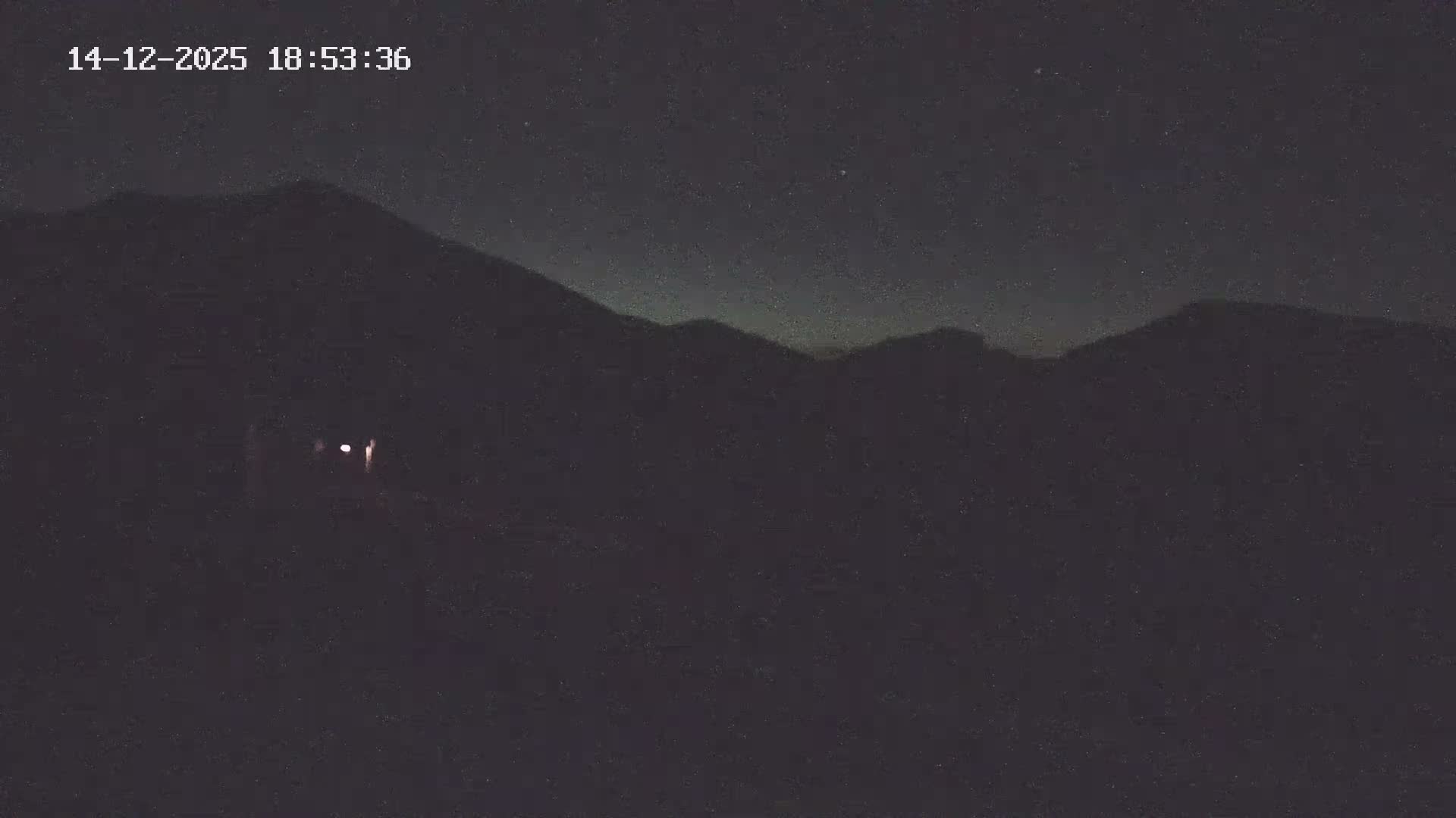 The image displays a snow-covered ground with uneven ridges and some visible debris, suggesting cold, wintery conditions.