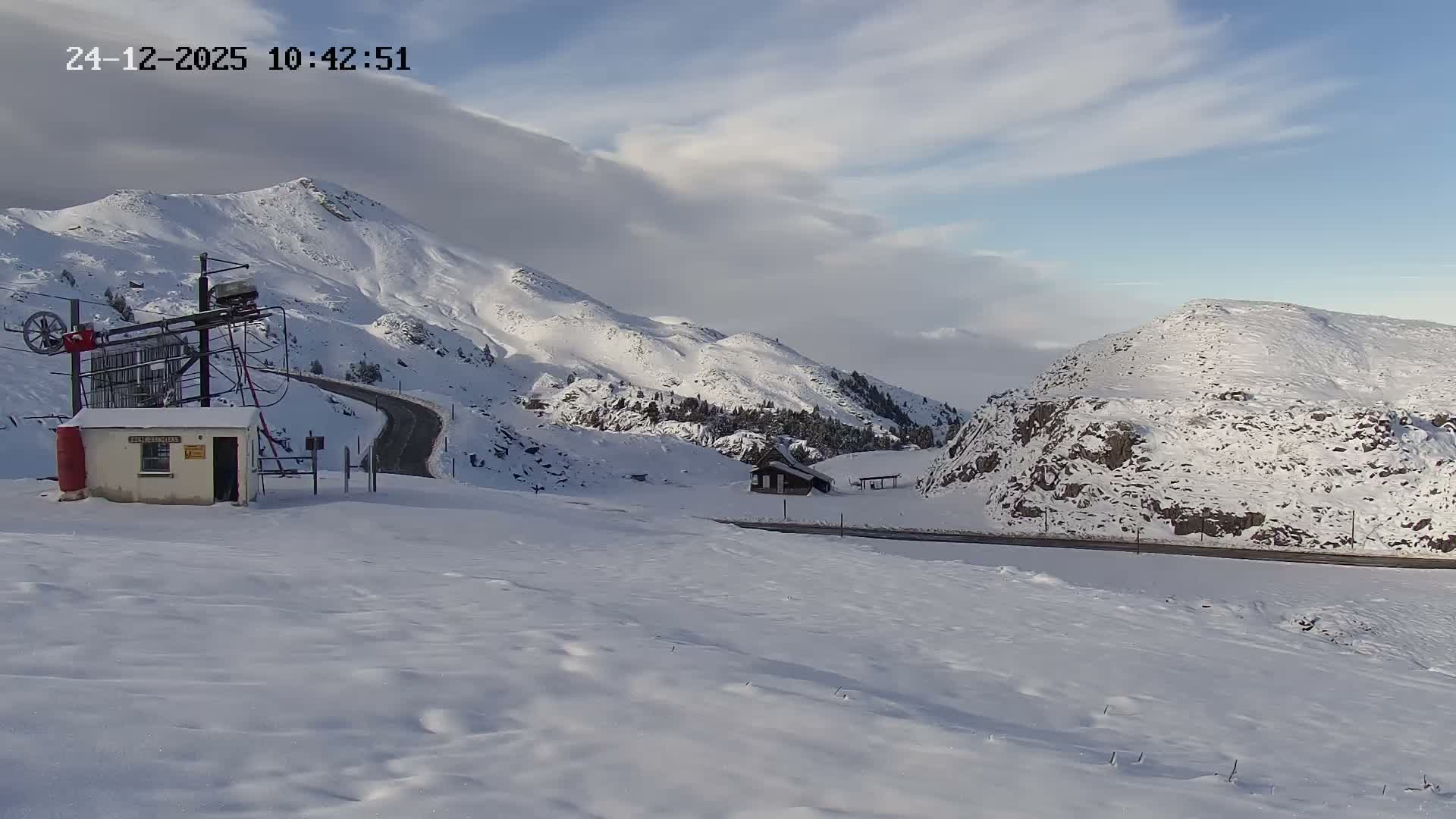 The image displays a snow-covered ground with uneven ridges and some visible debris, suggesting cold, wintery conditions.