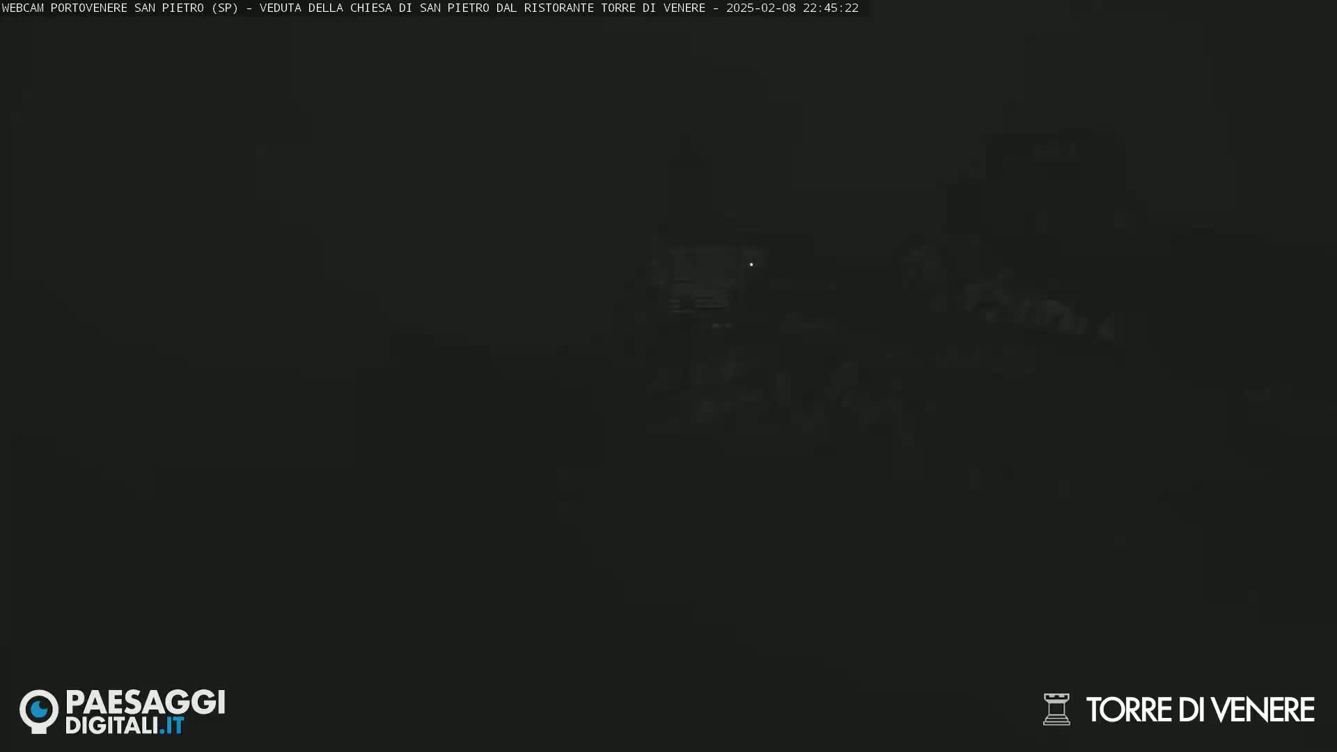 A dark, nighttime view of a dimly lit structure.