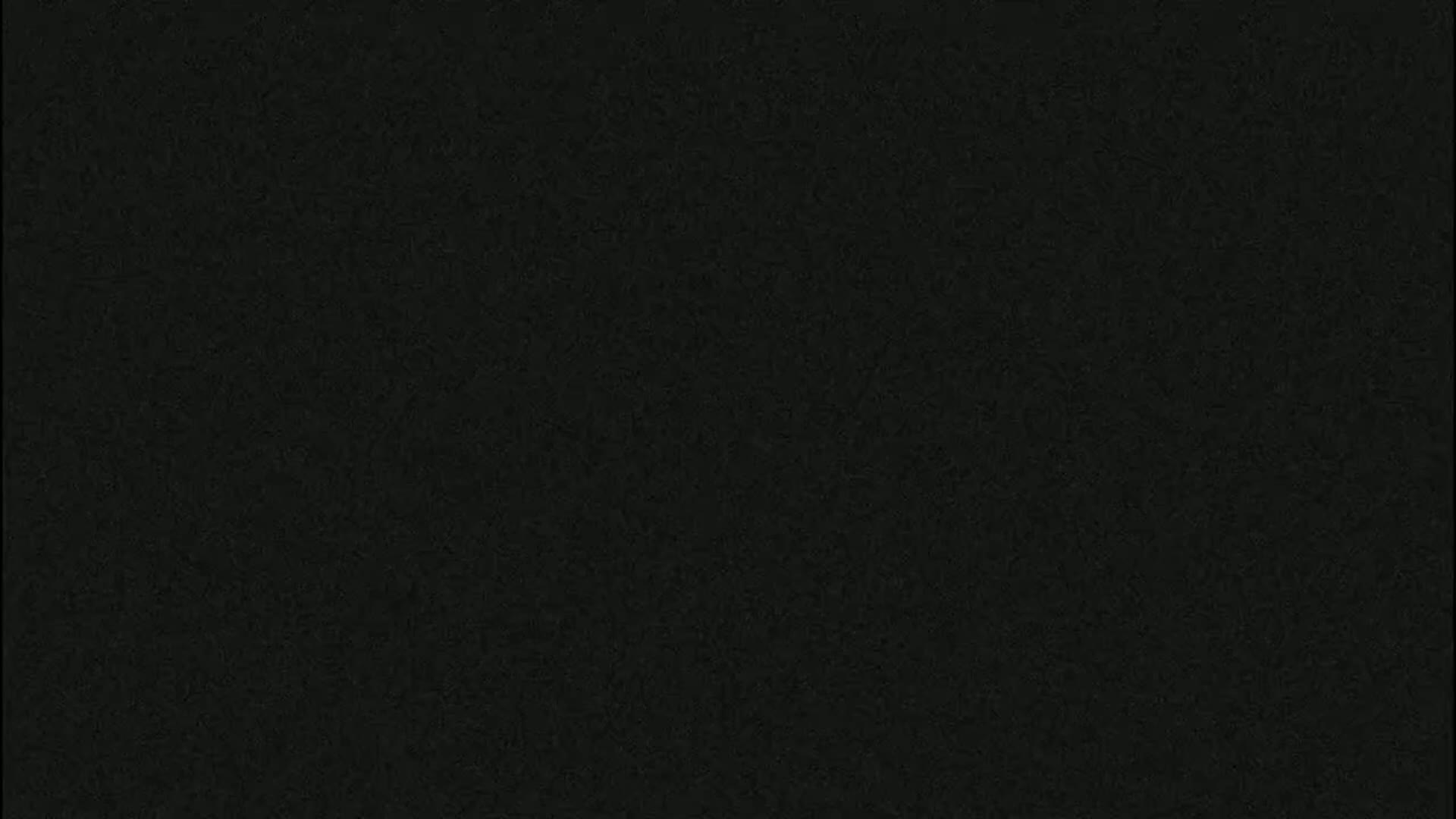 The image shows a solid, dark-grey textured background.