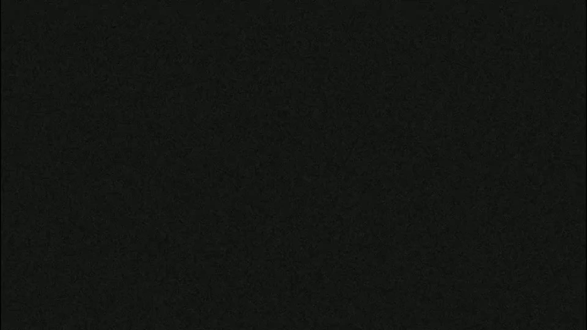 The image shows a dark gray, textured surface.