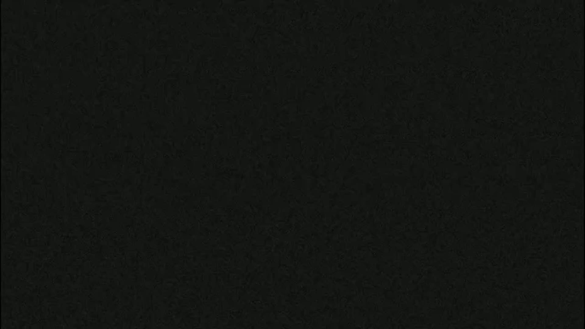 The image is a solid dark-grey background with a slightly textured surface.