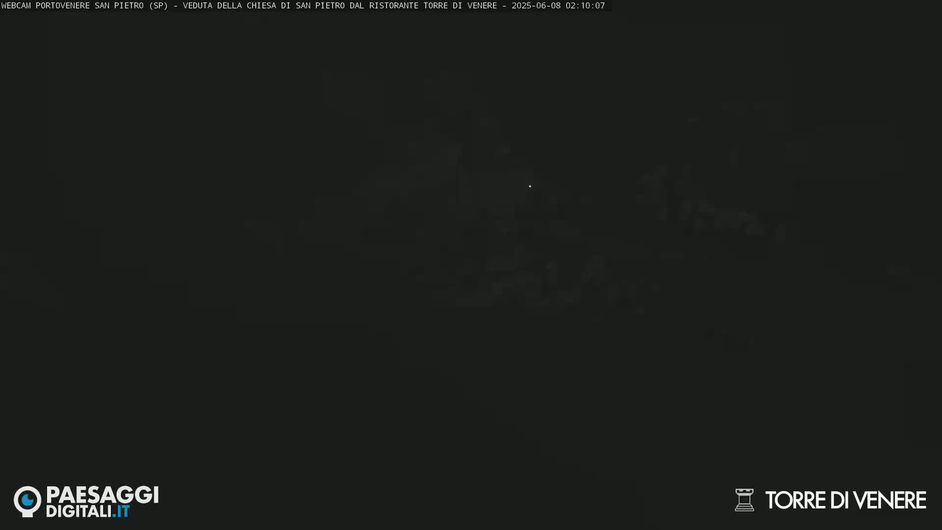 A very dark, nighttime image shows a blurry, indistinct view of a landscape.