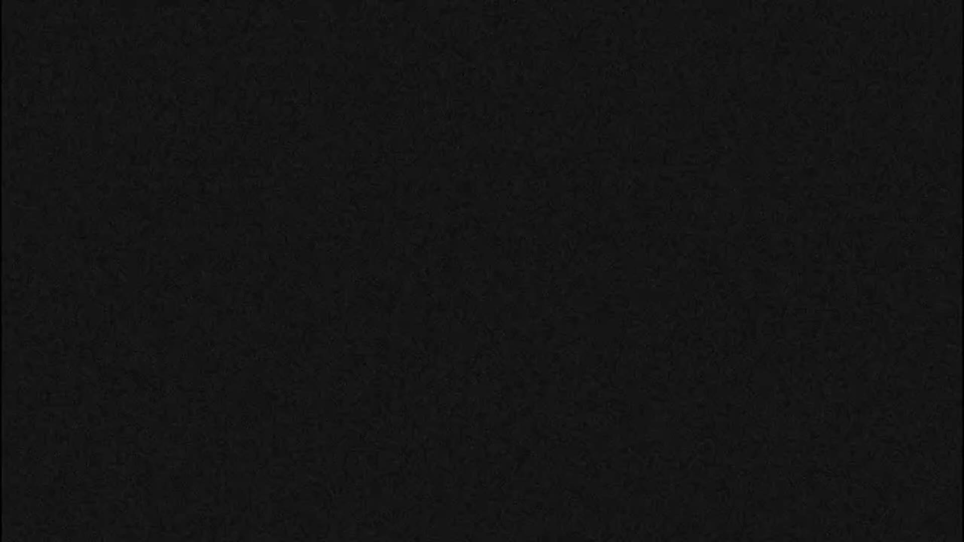 The image is entirely black with a subtle, dark gray noise pattern, showing no discernible objects or features.