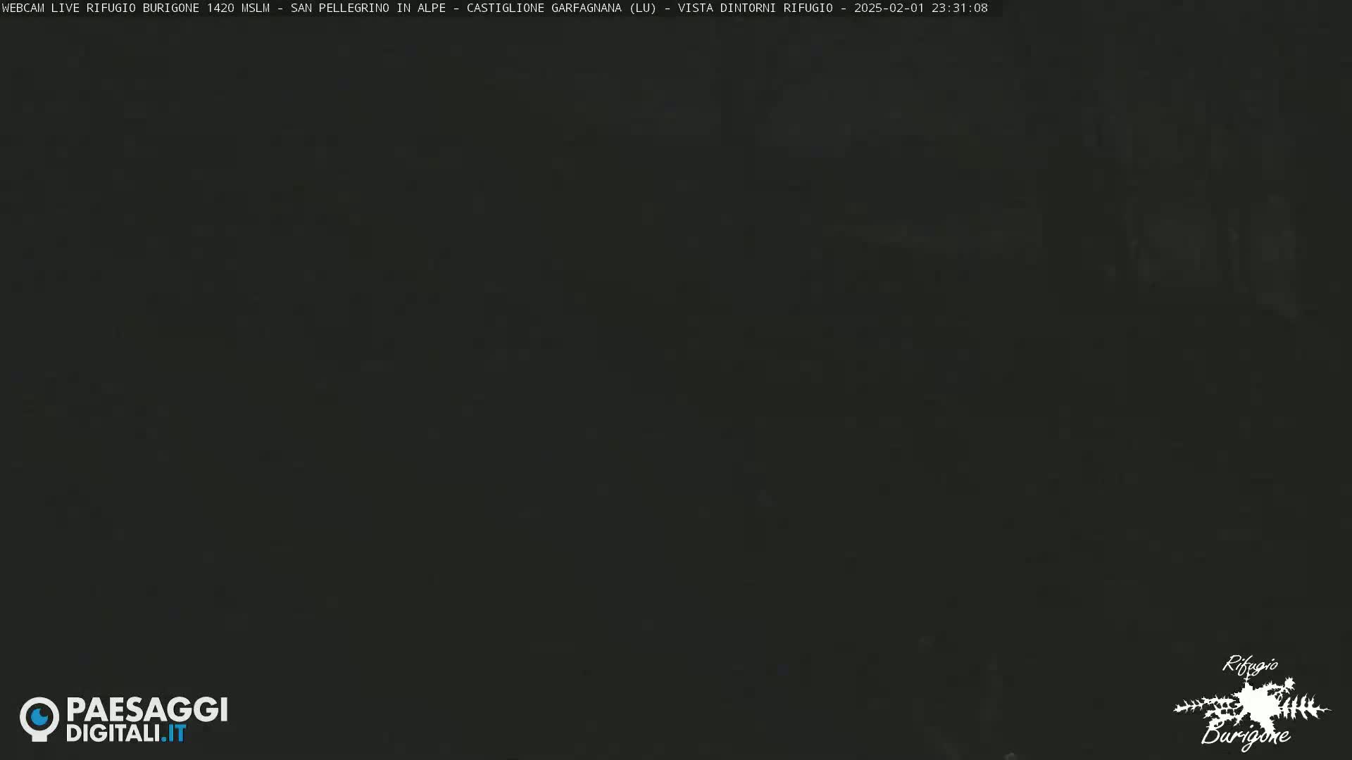 A dark, nighttime image shows a mostly featureless, dark gray-black scene.