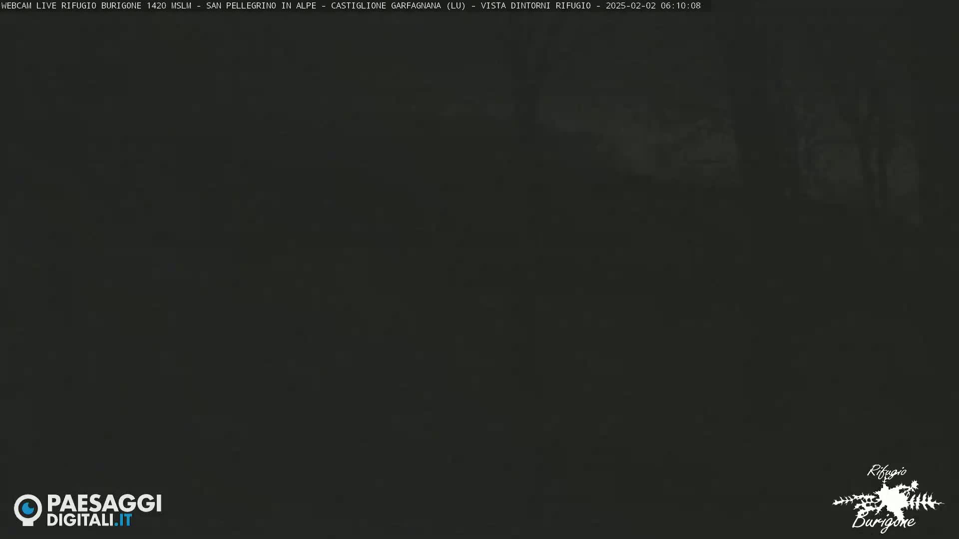 A dark, blurry image shows an outdoor scene at night or in low-light conditions.