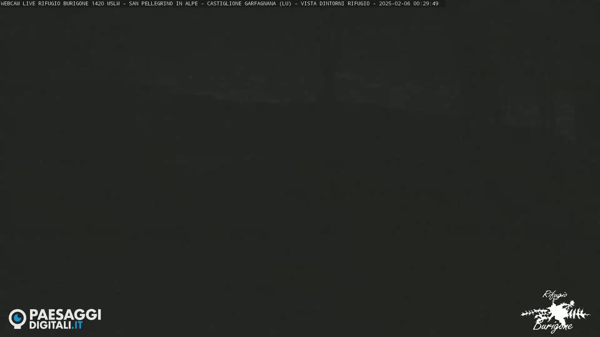 A dark, nighttime image shows a mostly obscured view of a landscape.