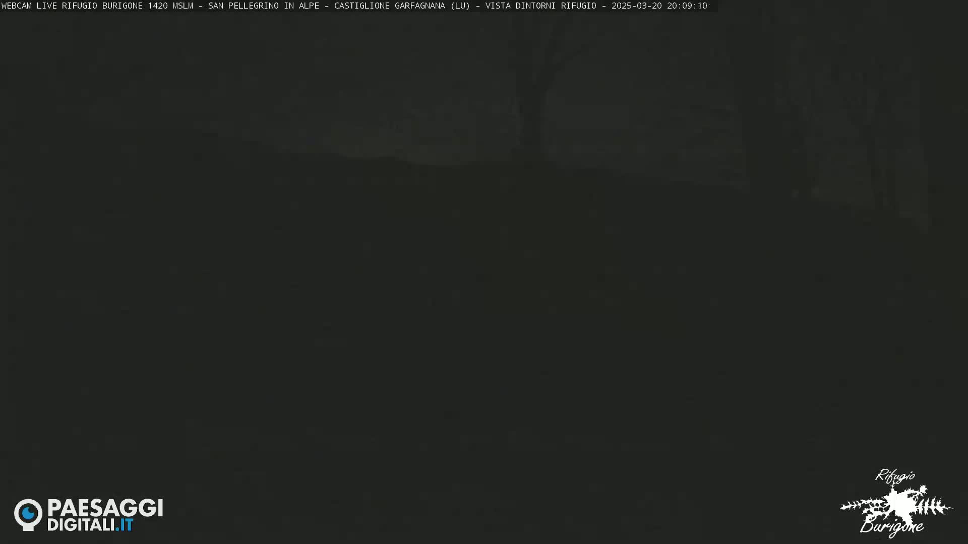 A dark, nighttime outdoor scene shows a mostly indistinct landscape under a dark sky.