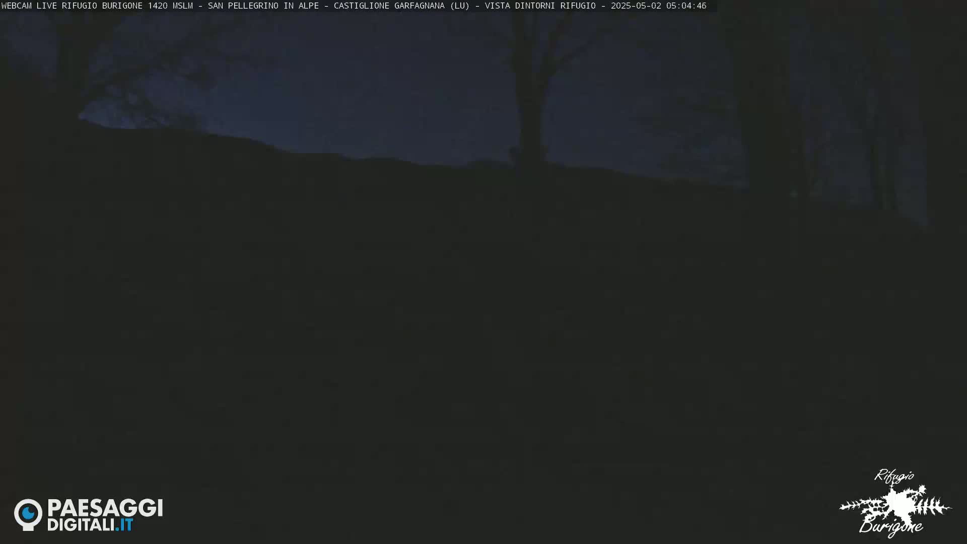 A dark, nighttime outdoor scene shows a hilltop silhouetted against a dusky sky.