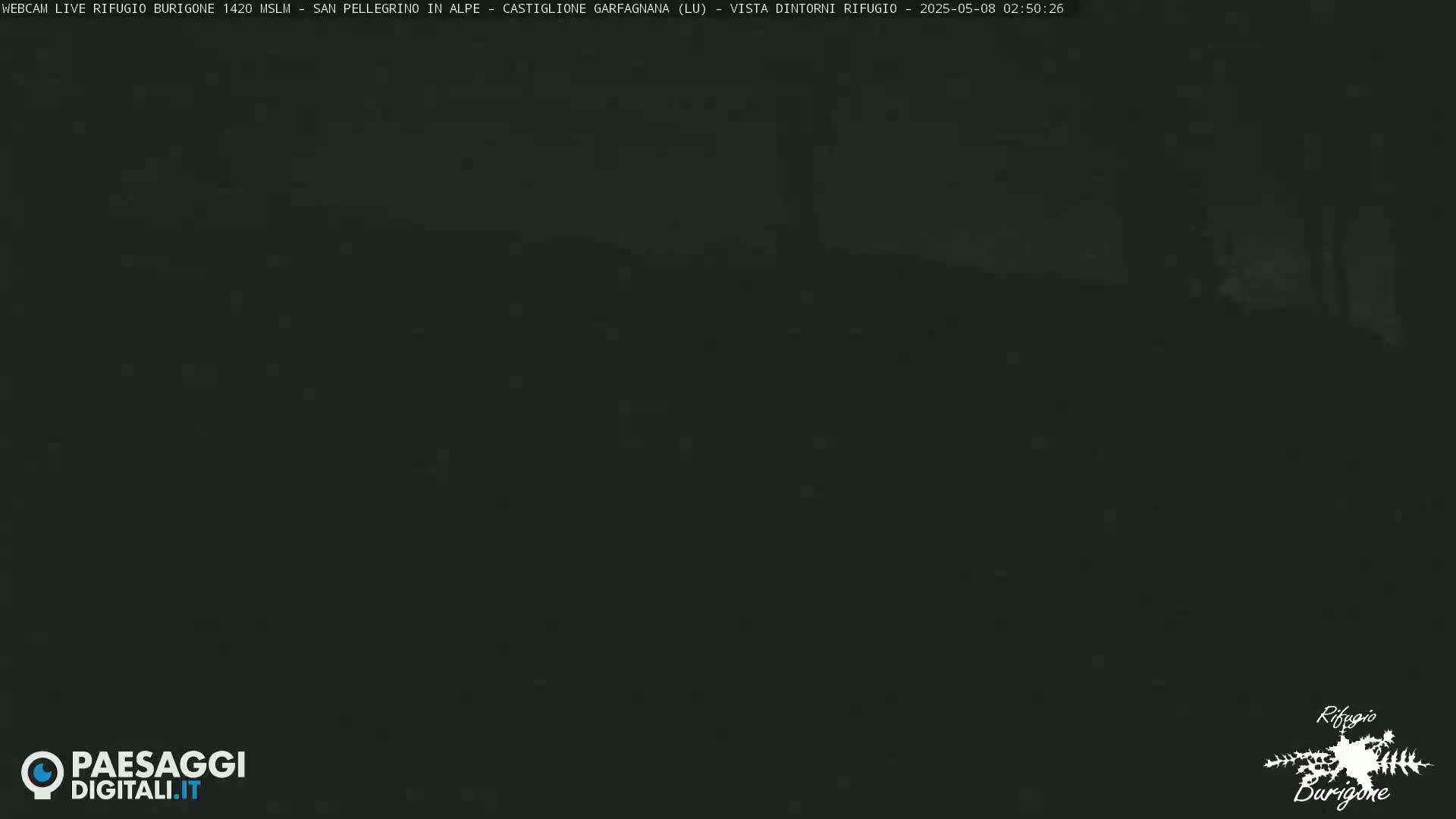 A dark, nighttime image shows a mostly indistinguishable landscape.