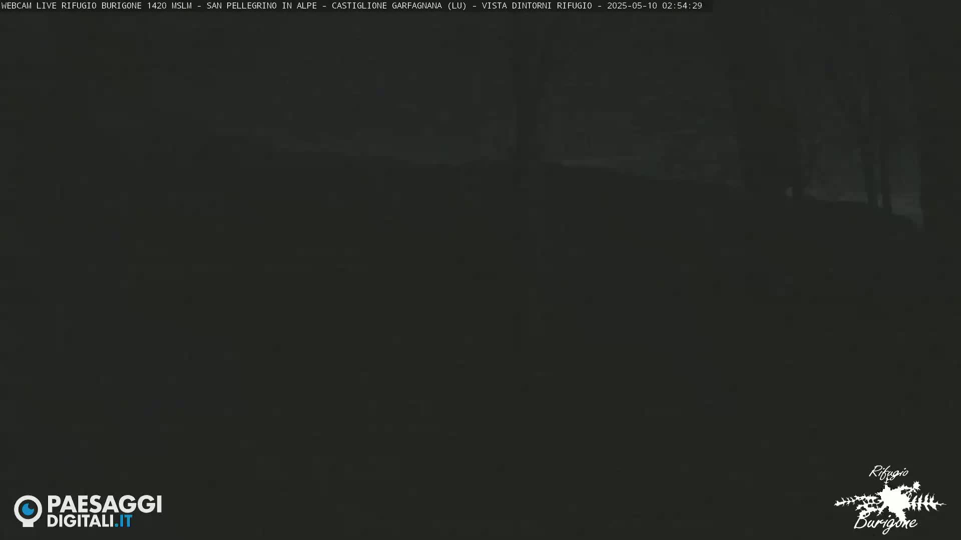 A dark, nighttime scene shows a hilltop shrouded in shadow.