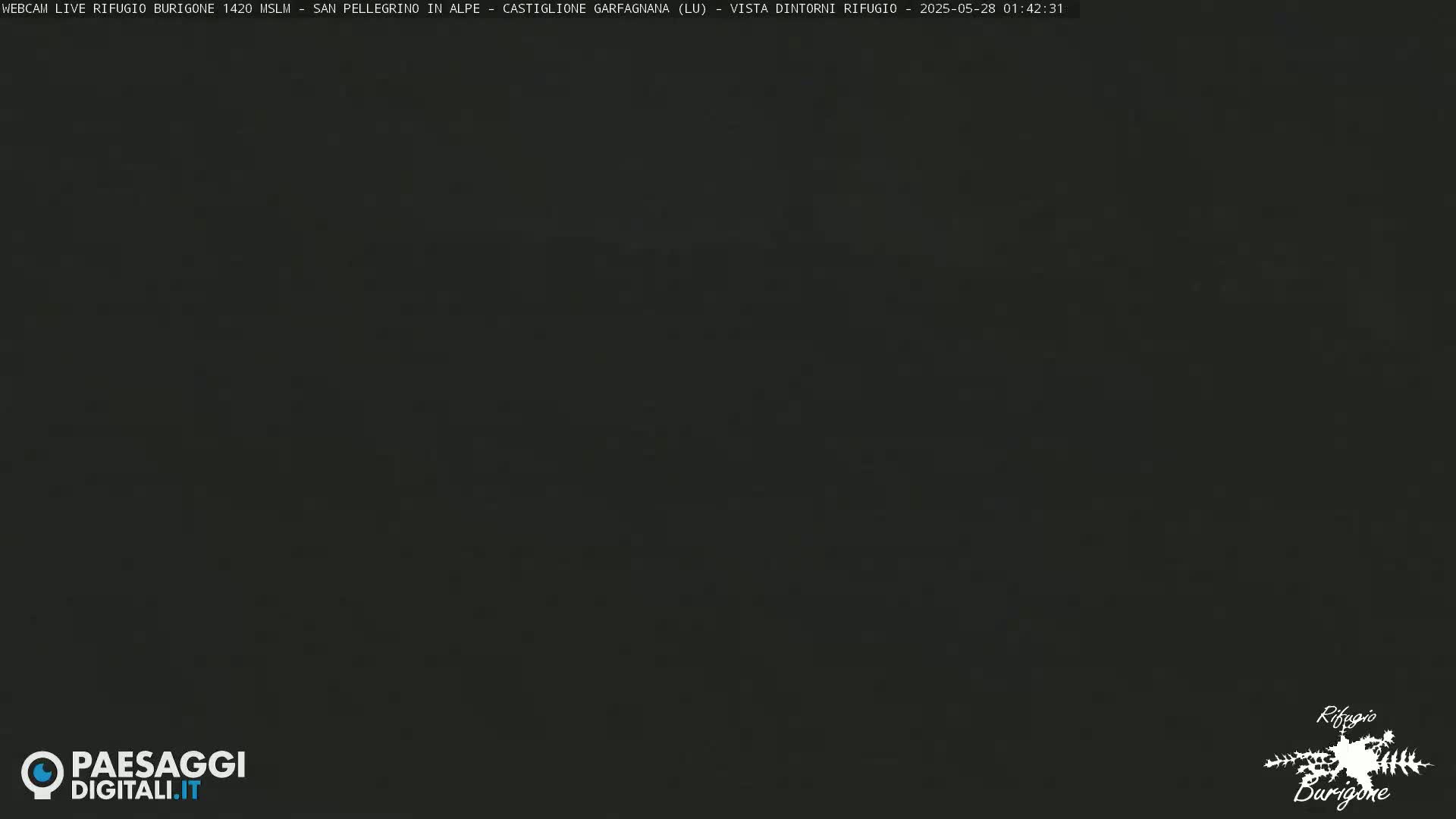 A dark, nighttime image shows a mostly black screen with a few faint, lighter areas.