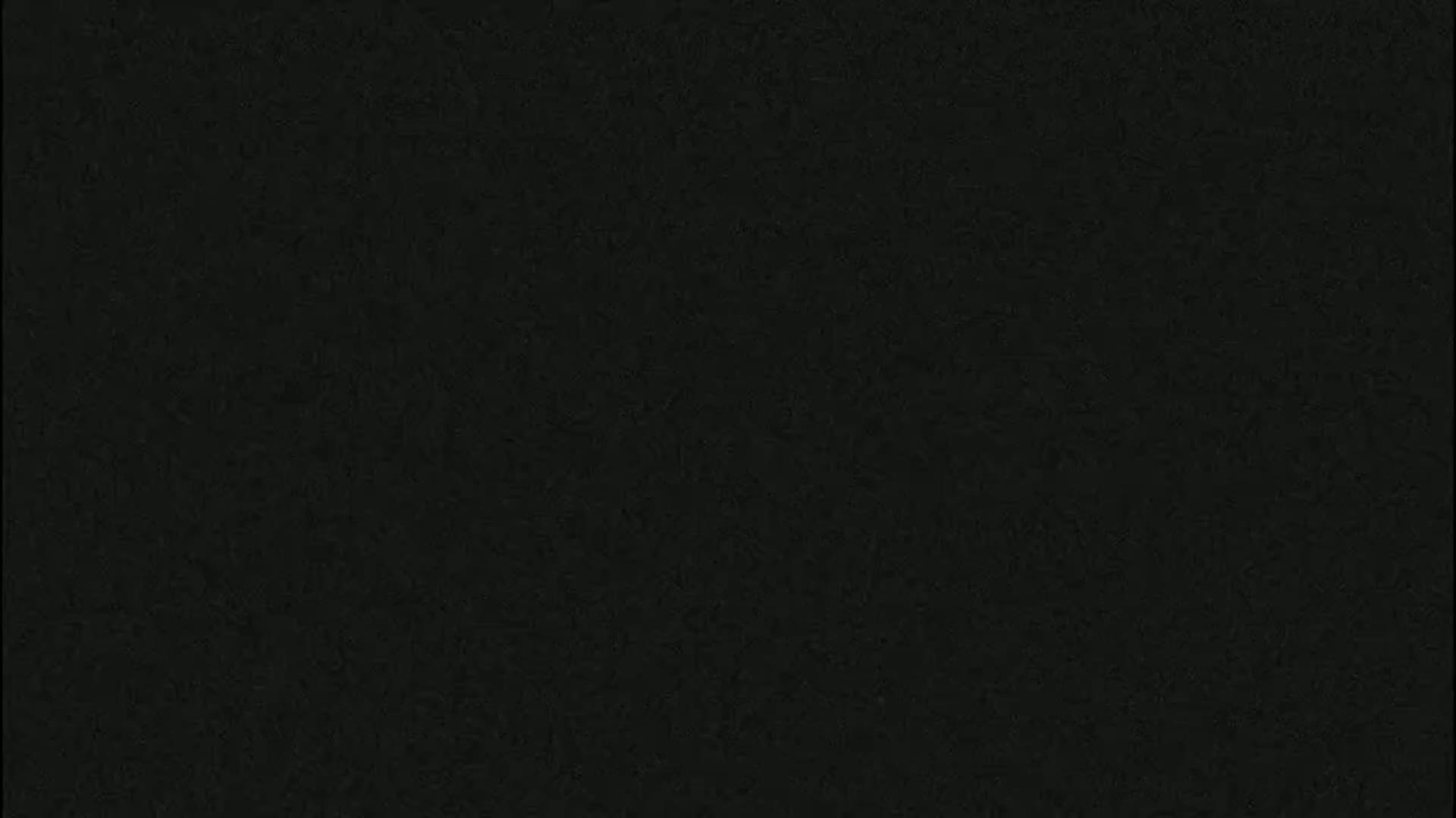 The image is a solid dark-grey or black background with a slightly textured surface.