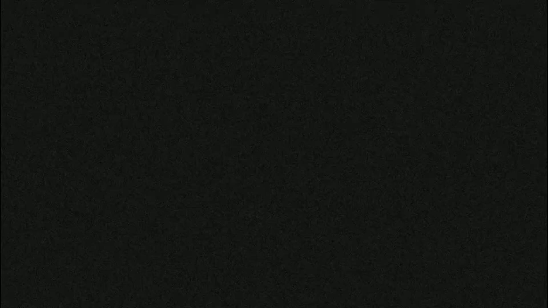 The image shows a dark gray or black textured surface.