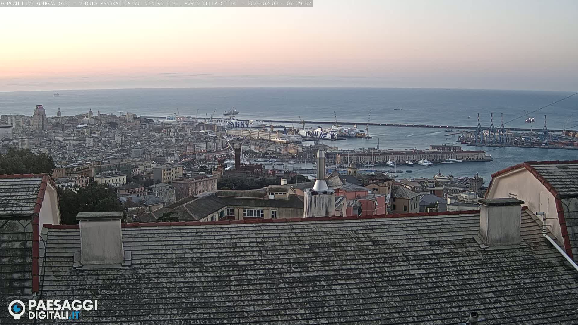 A panoramic view of a city harbor and cityscape under a calm, dusky sky.