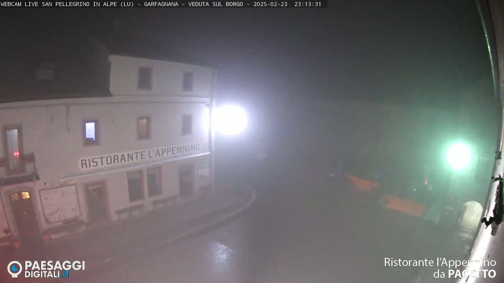 A nighttime view of a restaurant called "Ristorante L'Appennino" shrouded in fog.