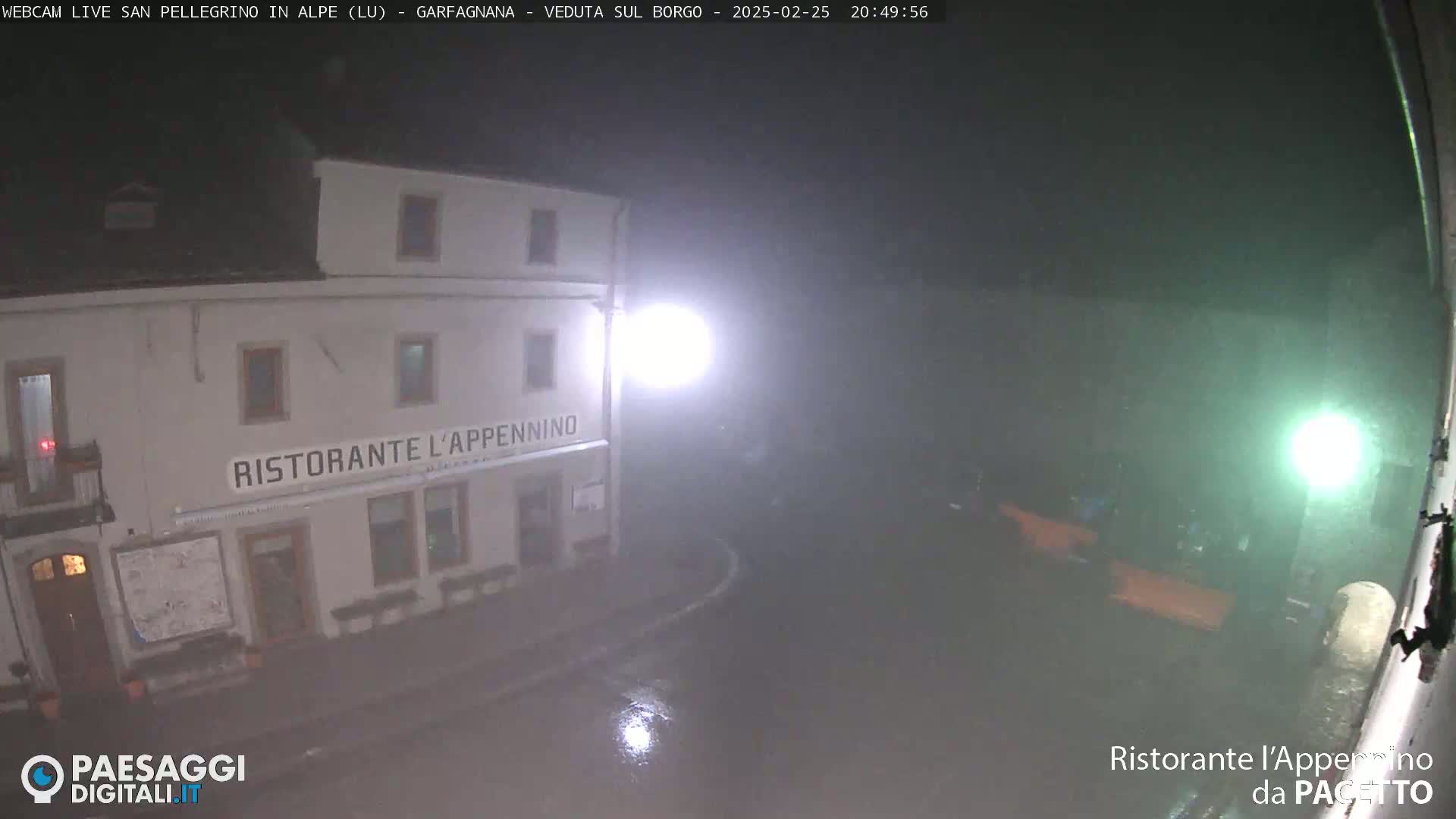 A nighttime, rainy view of a restaurant called "Ristorante L'Appennino," situated on a street corner with minimal visibility due to the weather.