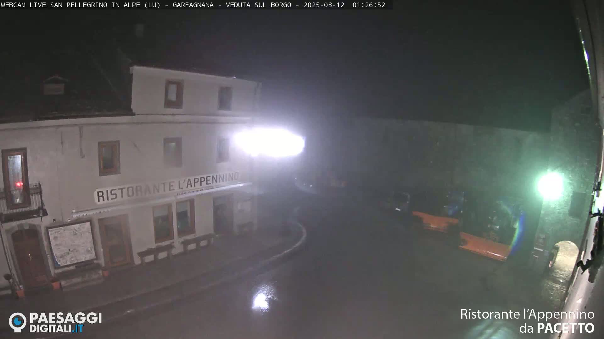 A nighttime view of a restaurant, Ristorante L'Appennino, in the rain.