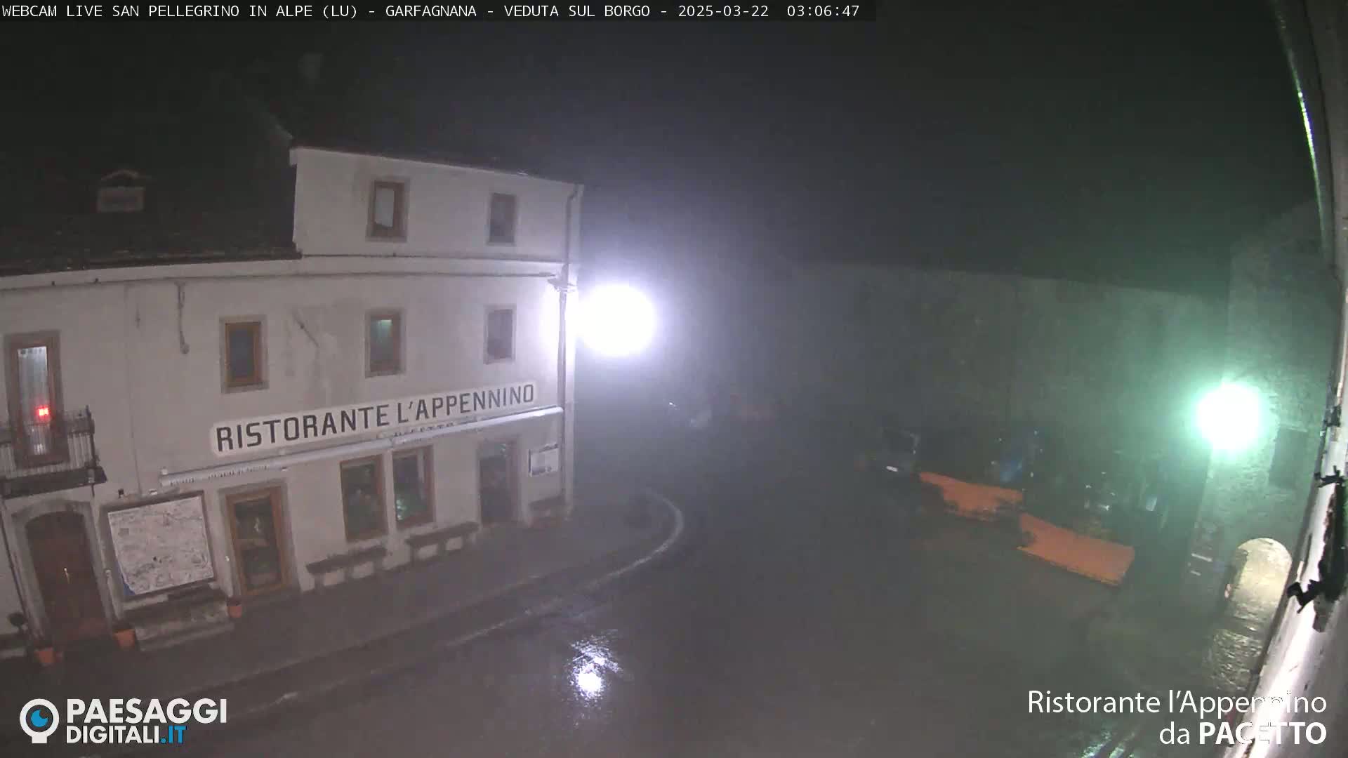 A nighttime view of a wet town square showing a restaurant called "Ristorante l'Appennino" under dim lighting.