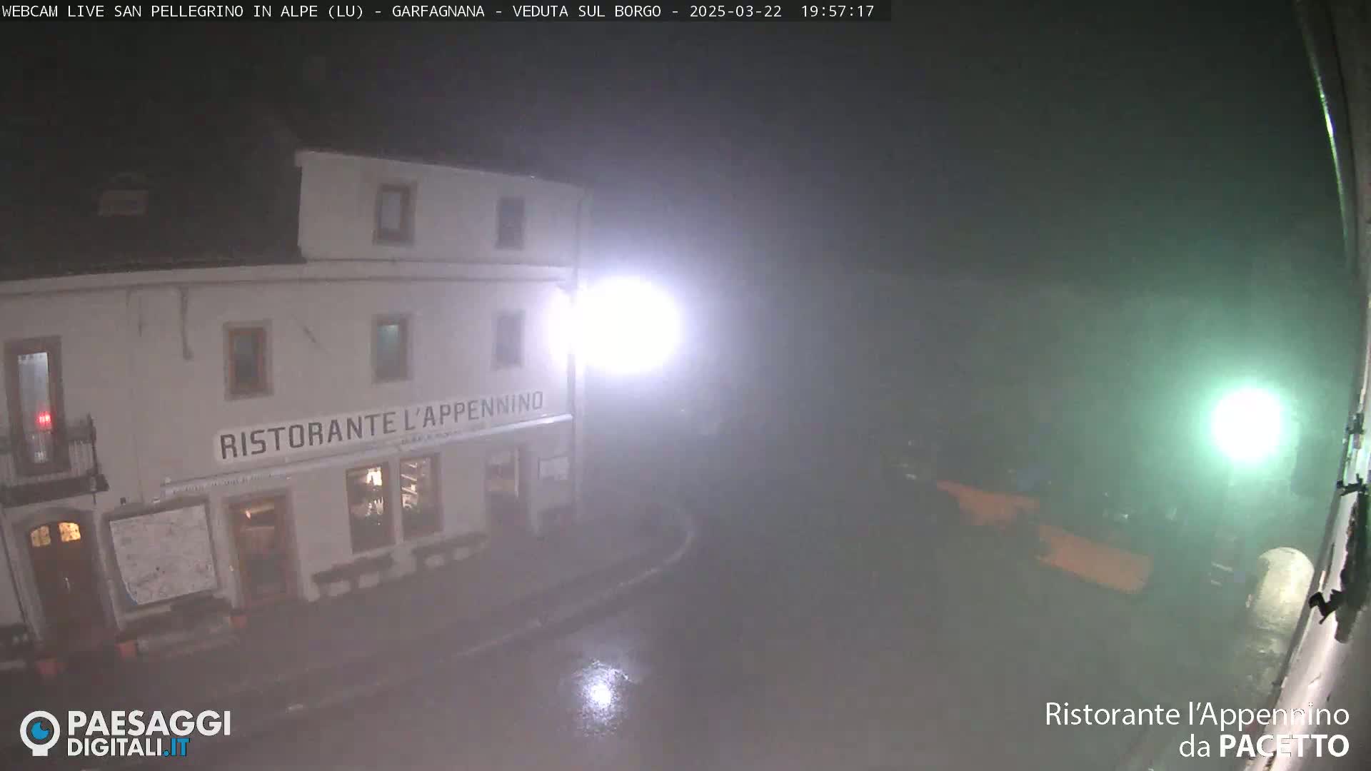 A nighttime view of a restaurant, Ristorante L'Appennino, in the rain.