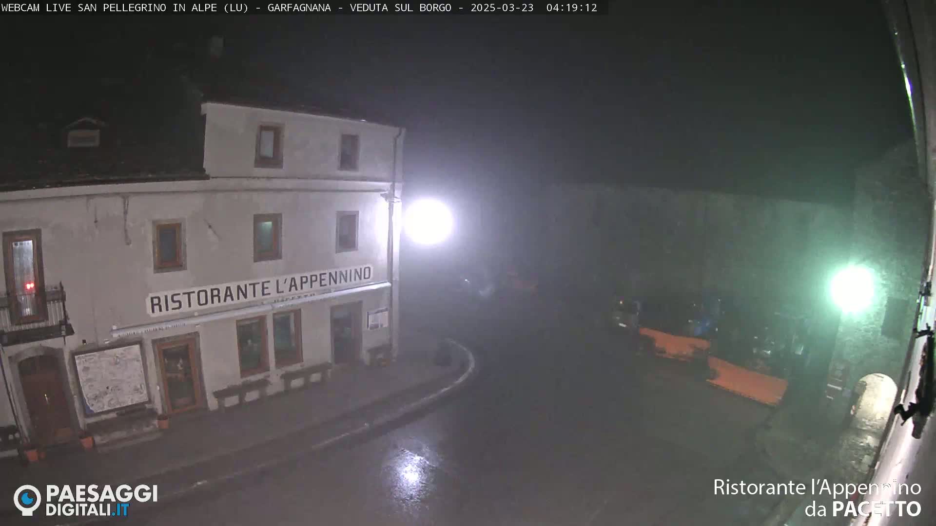 A nighttime, rainy view of a restaurant called "Ristorante l'Appennino" in a small town square.