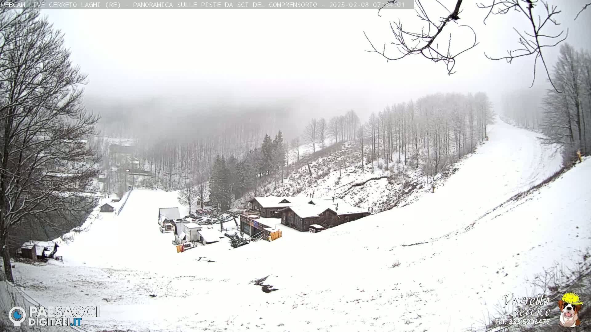 A snow-covered ski slope and lodge are visible under a foggy, snowy sky.