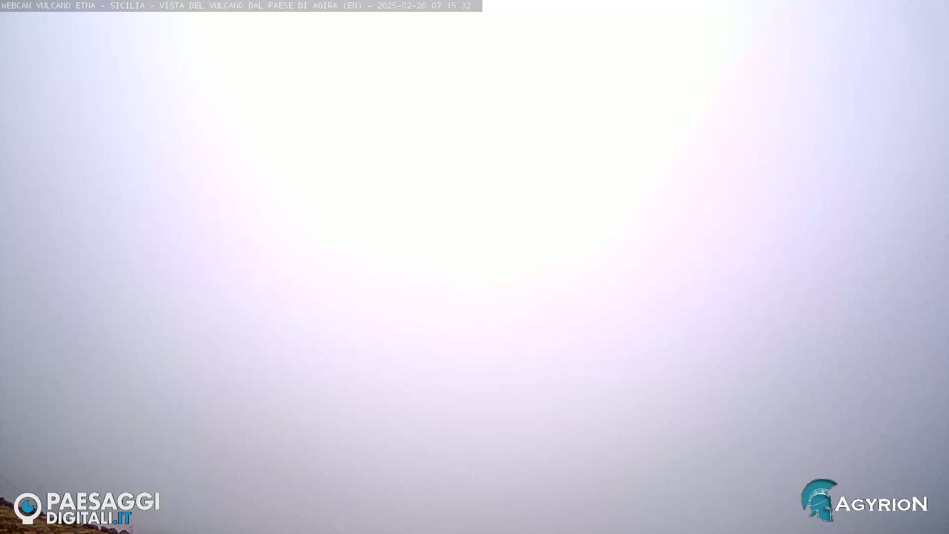 A hazy, light-purple sky is visible.