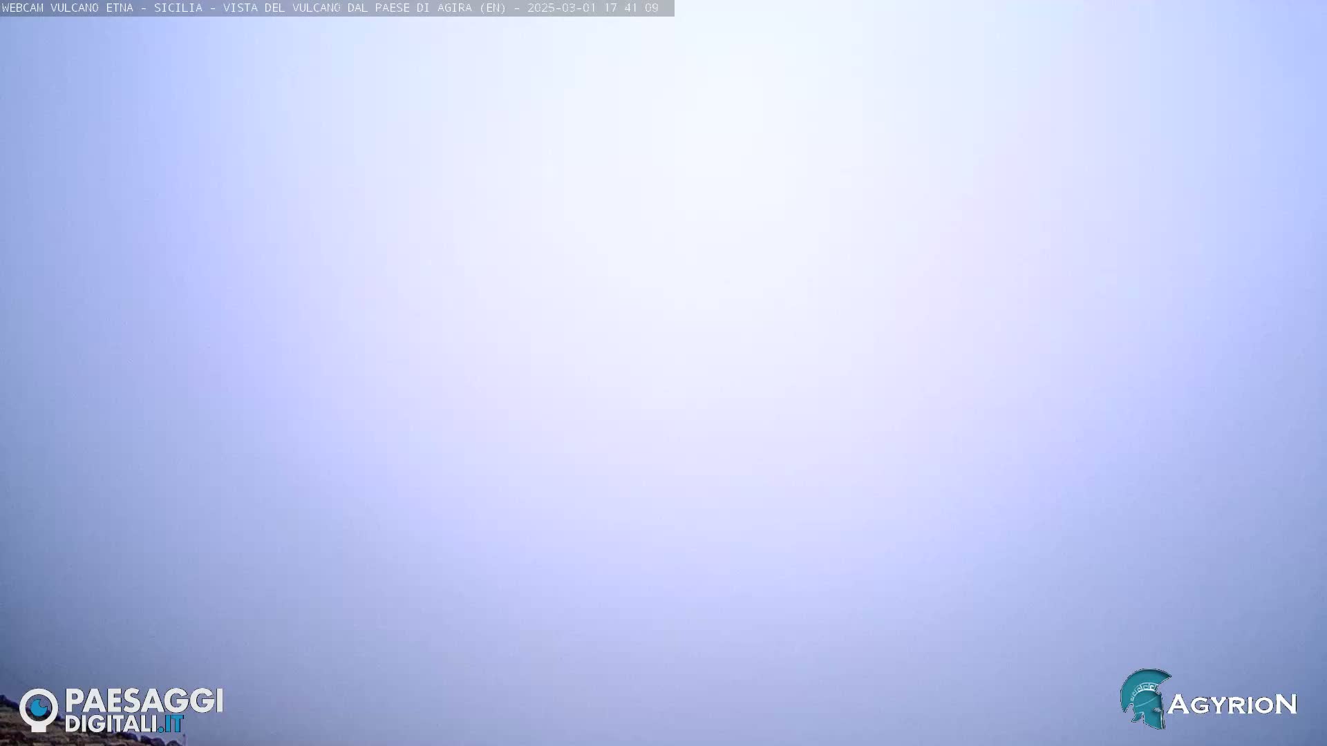 A hazy, light-blue sky fills the entire frame.