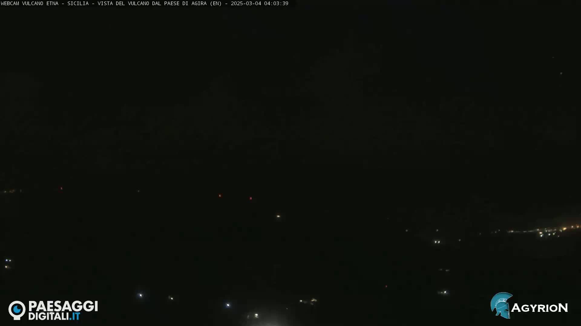 A nighttime long shot shows a dark landscape with a few distant lights visible.