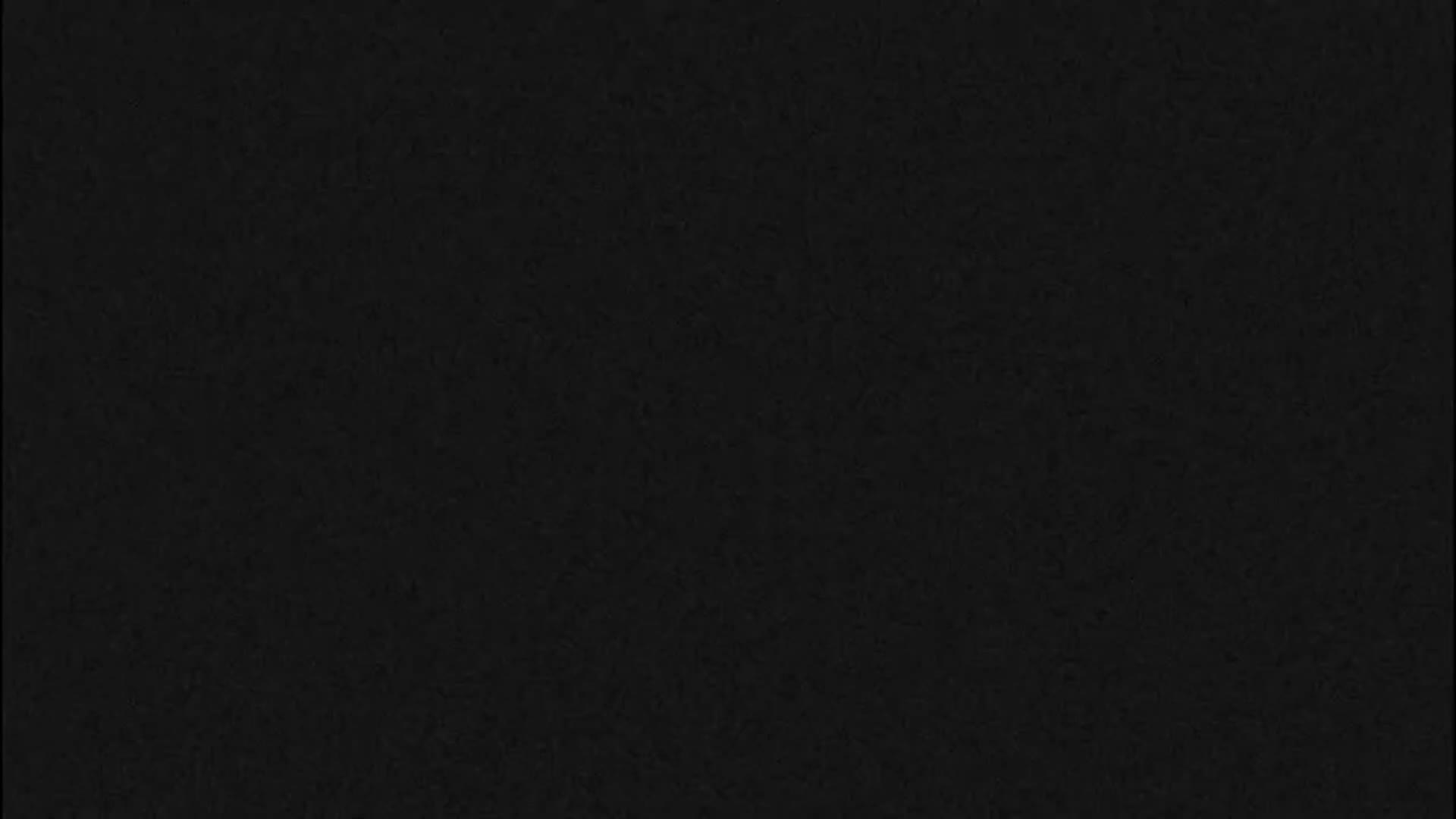 The image displays a solid black background with a subtle, uniform dark gray grainy texture.