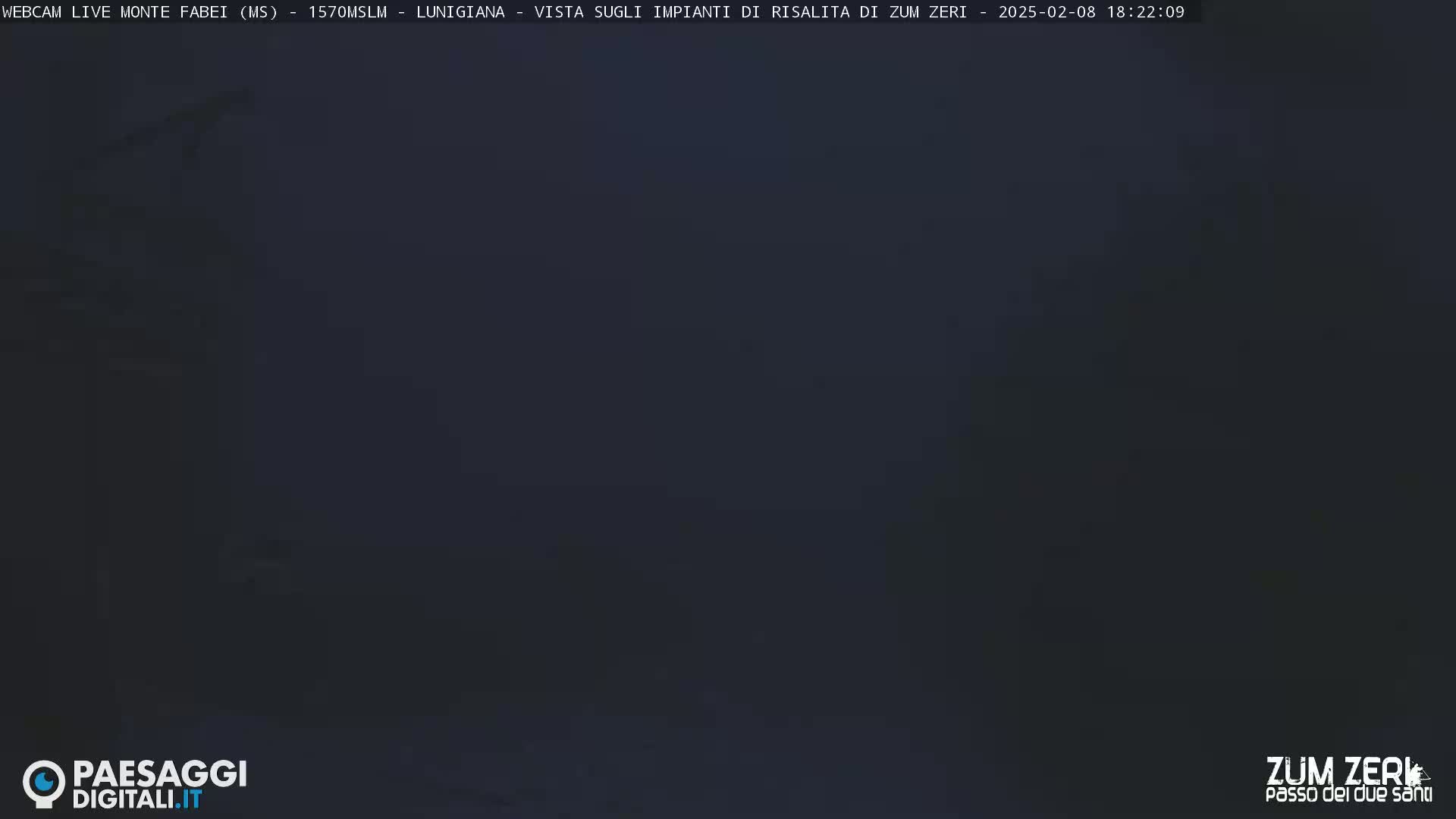 A dark, blurry image shows an indistinct, nighttime outdoor scene obscured by heavy fog or mist.