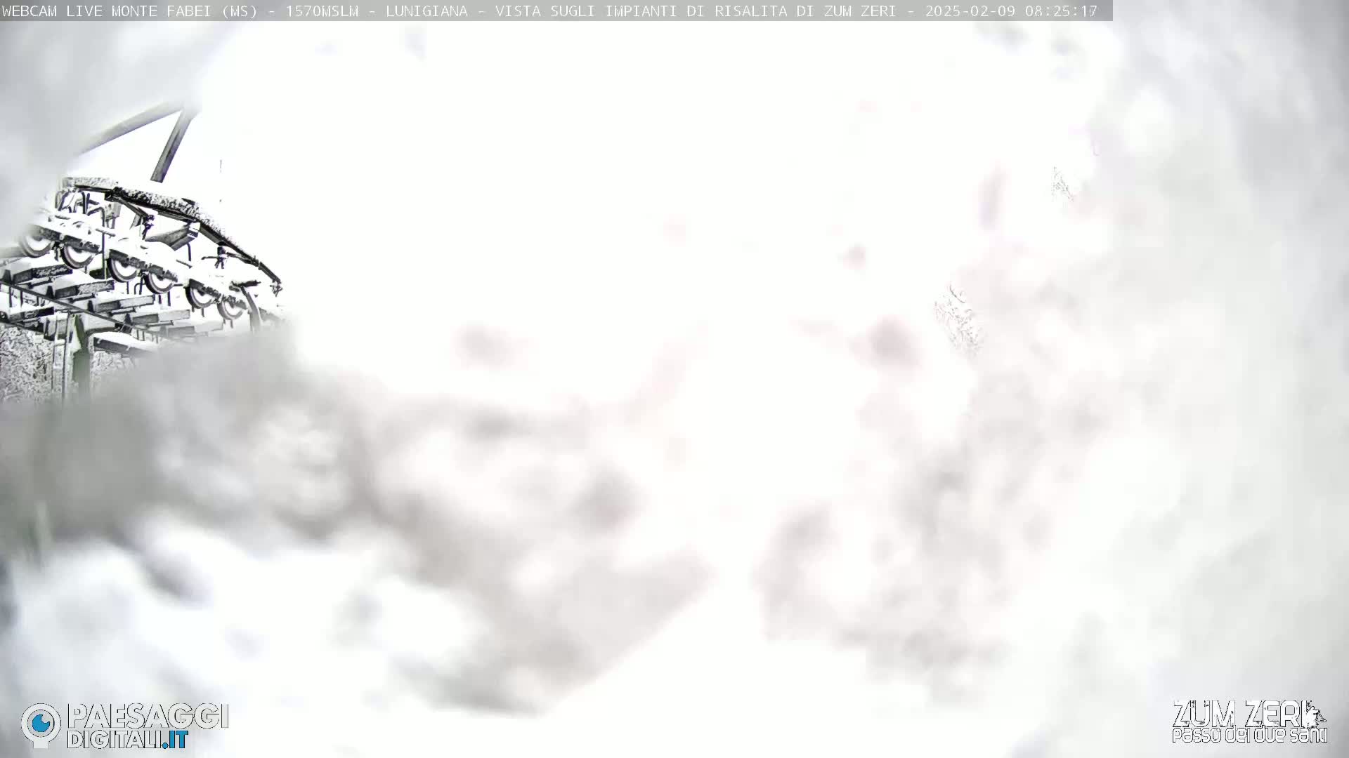 A snow-covered chairlift is partially visible through heavy snowfall.