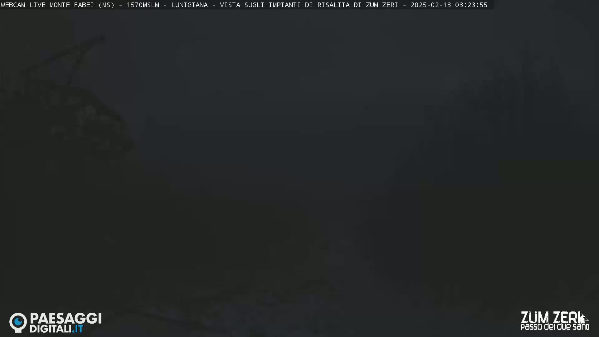 A dark, blurry image shows a mostly obscured view of a landscape at night or in very low light conditions.