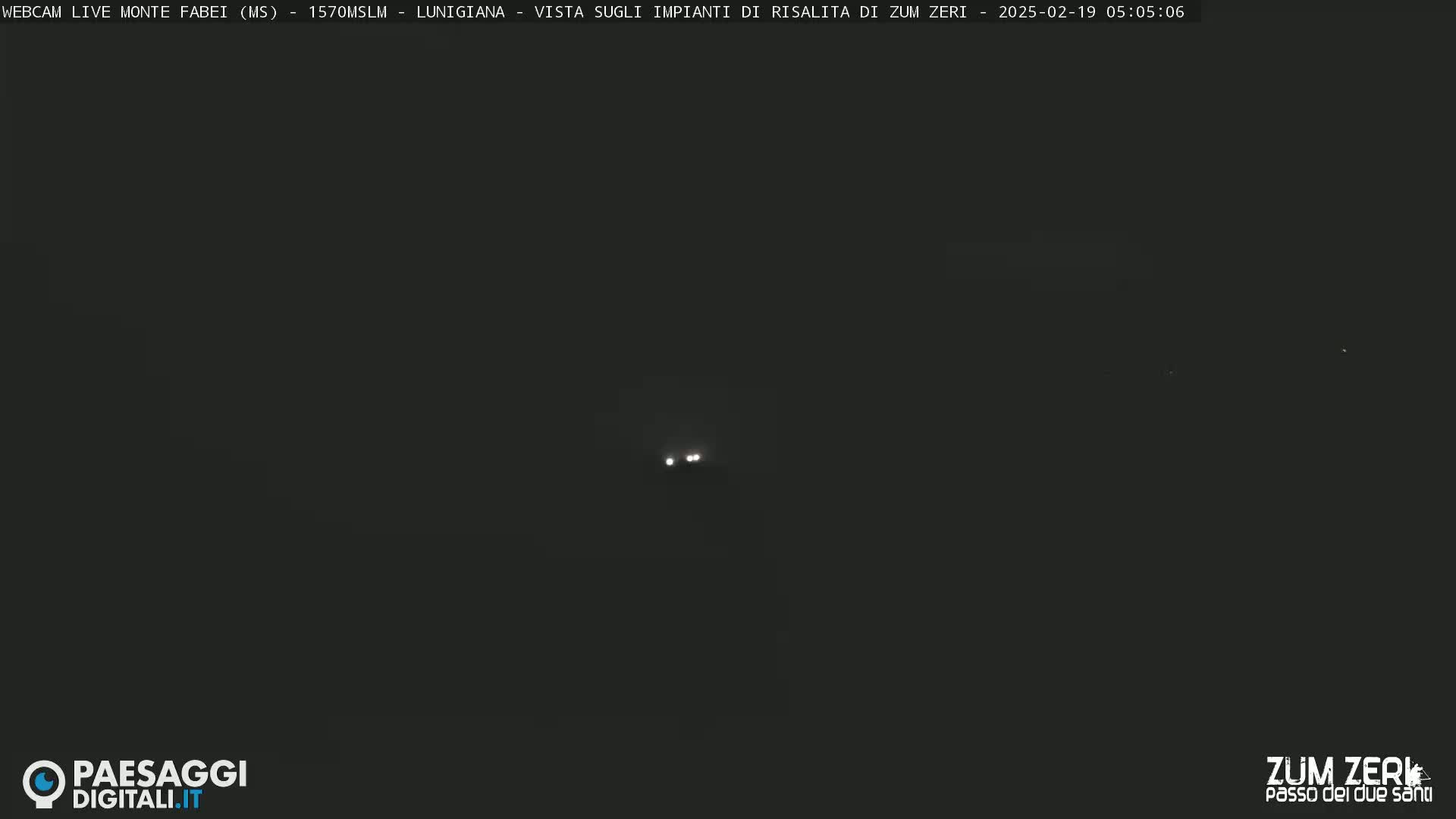 Two faint lights are visible in the dark night.