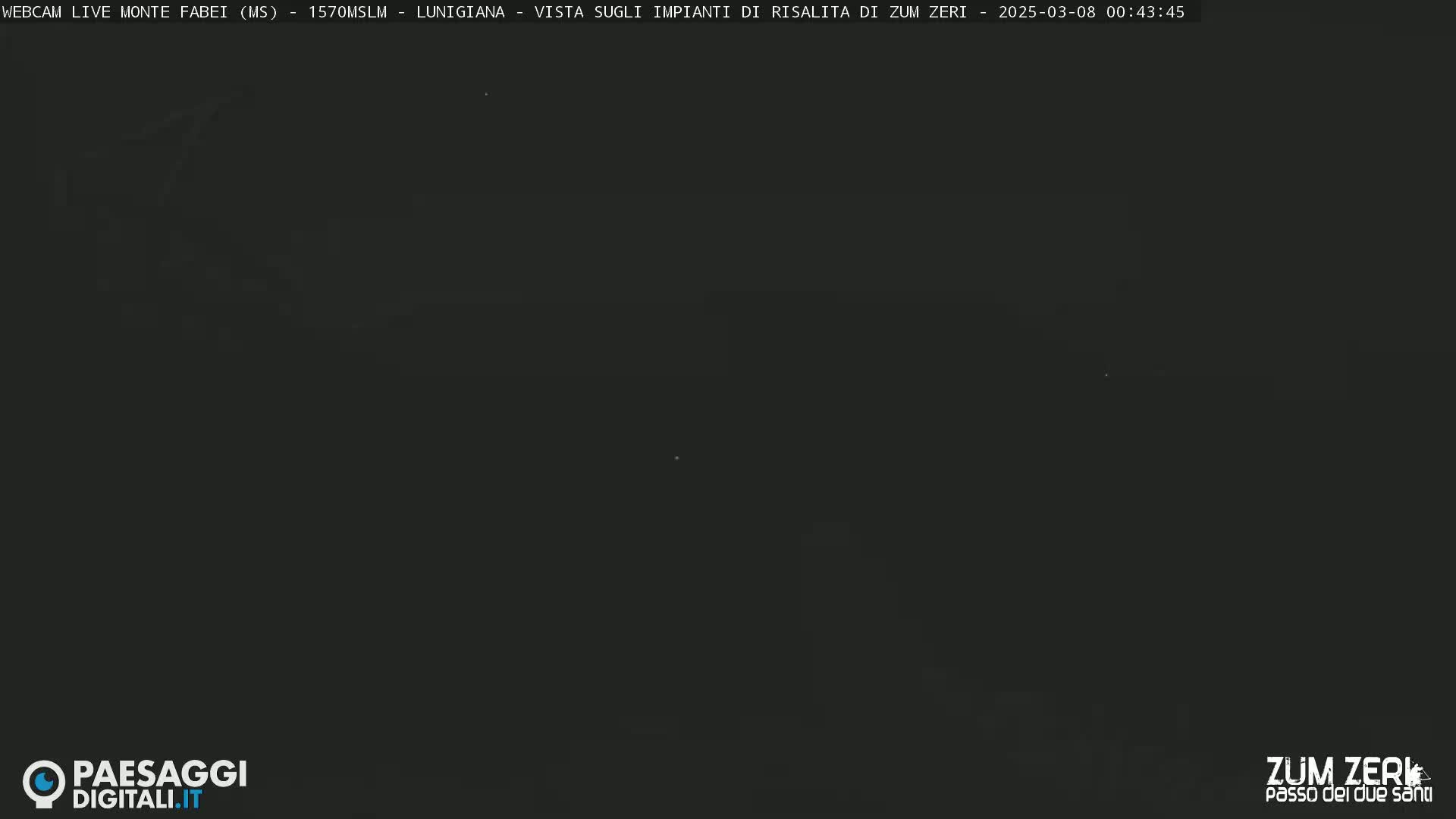 A dark, nighttime view of a mountain landscape.