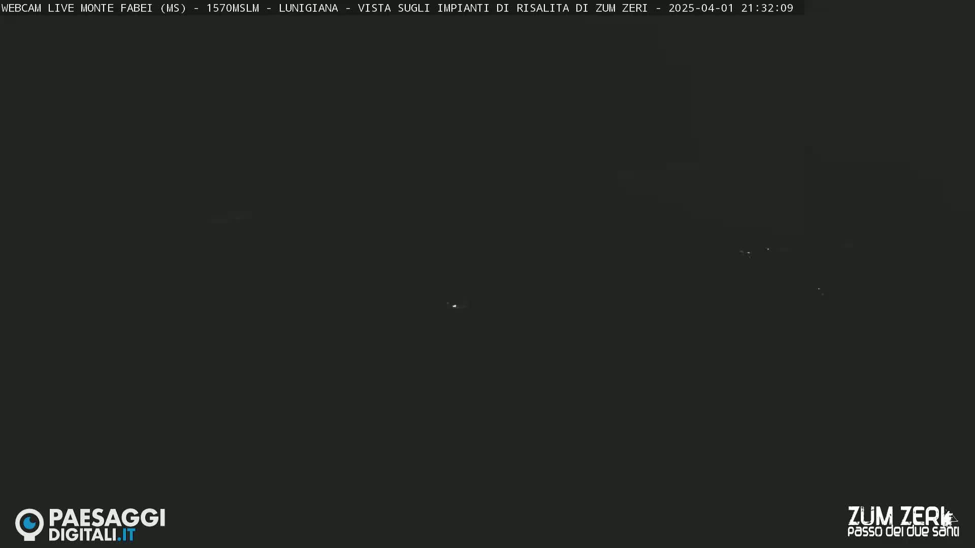 A nighttime long shot of dimly lit, distant lights.