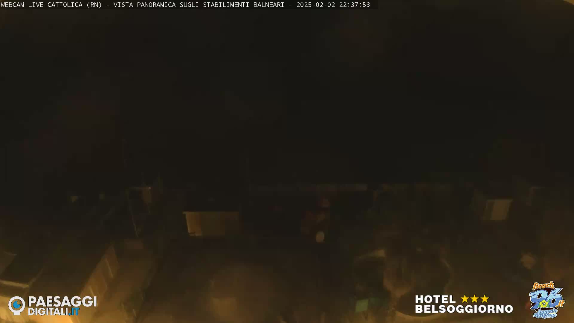 A nighttime, low-light view of a building complex, possibly beachside structures.