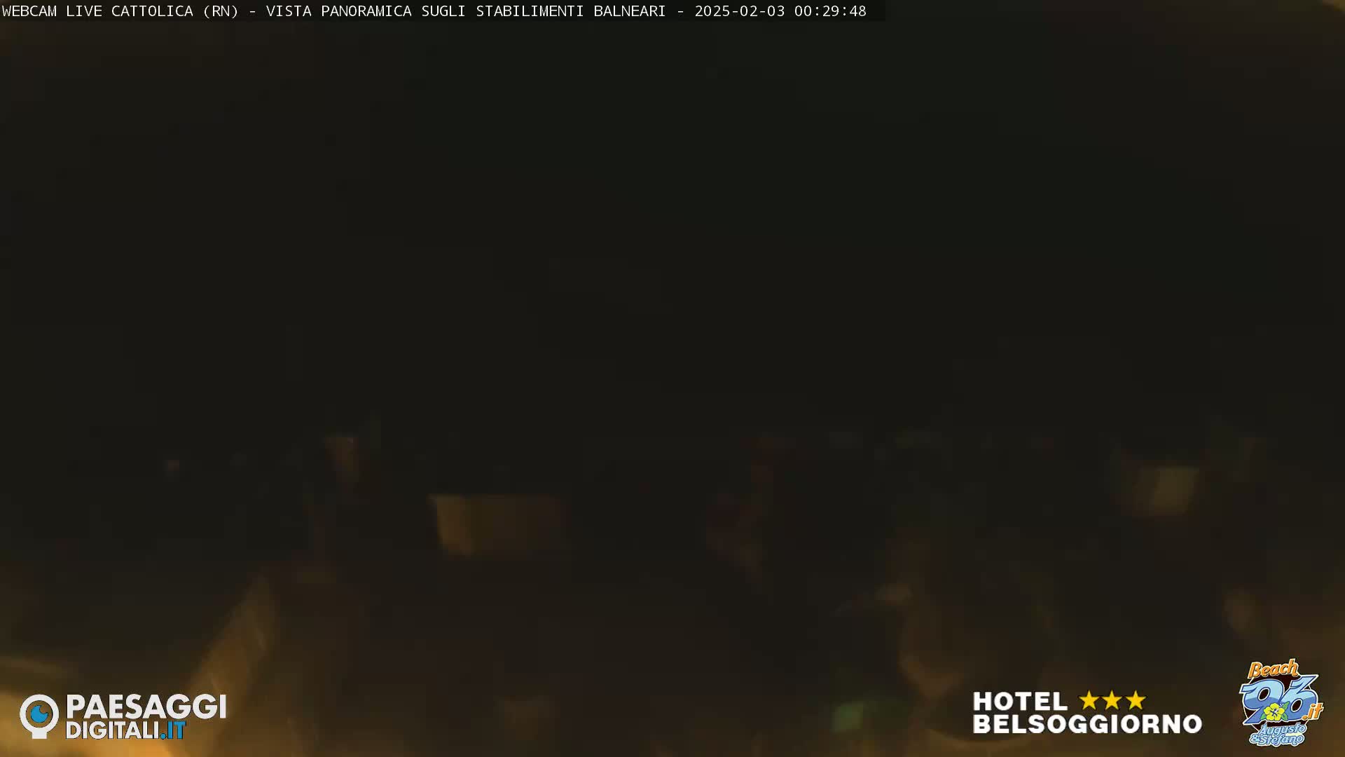 A dark, nighttime scene shows a blurry, indistinct view of what appears to be a beach area.