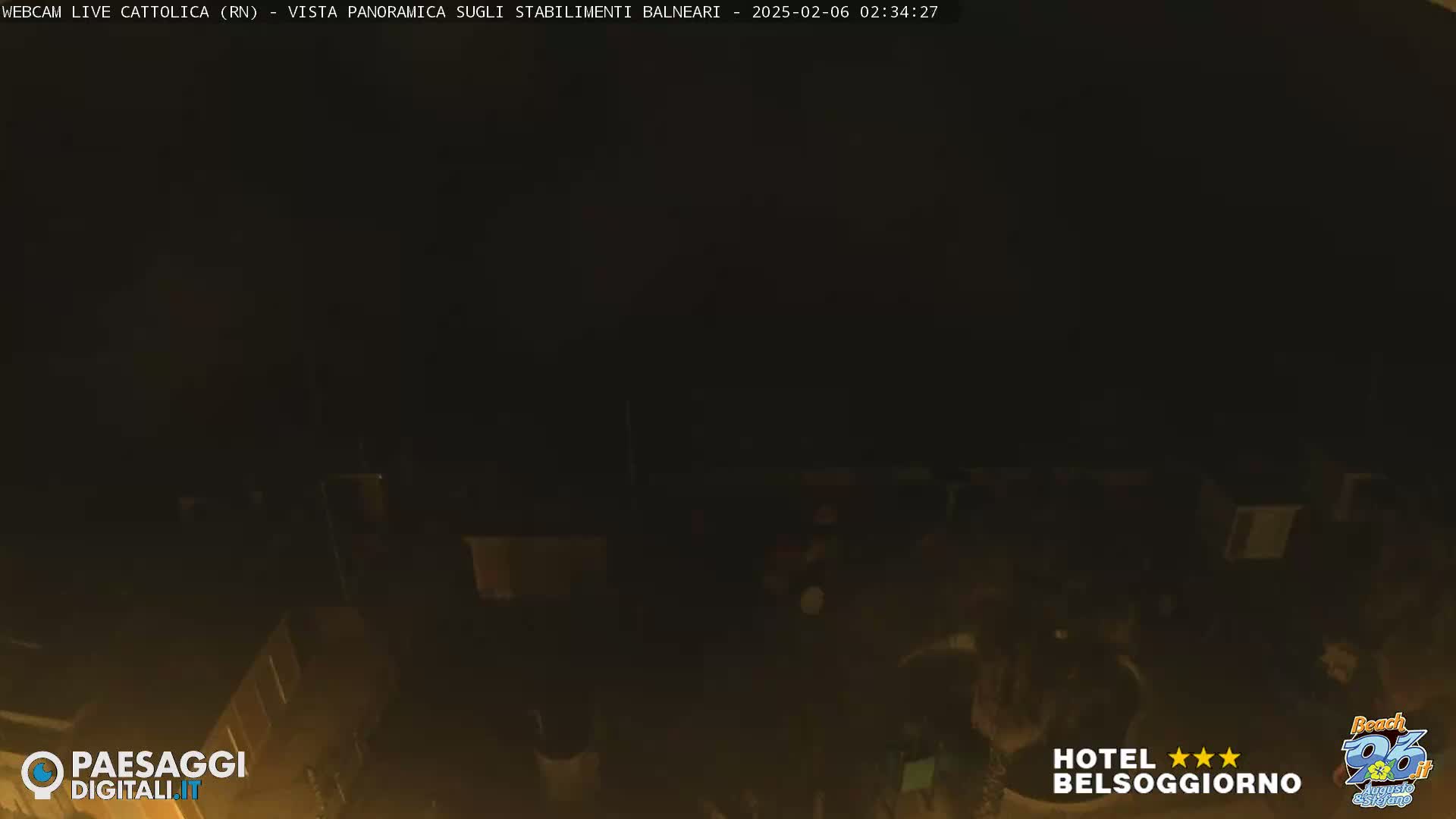 A nighttime, dark view of building rooftops.