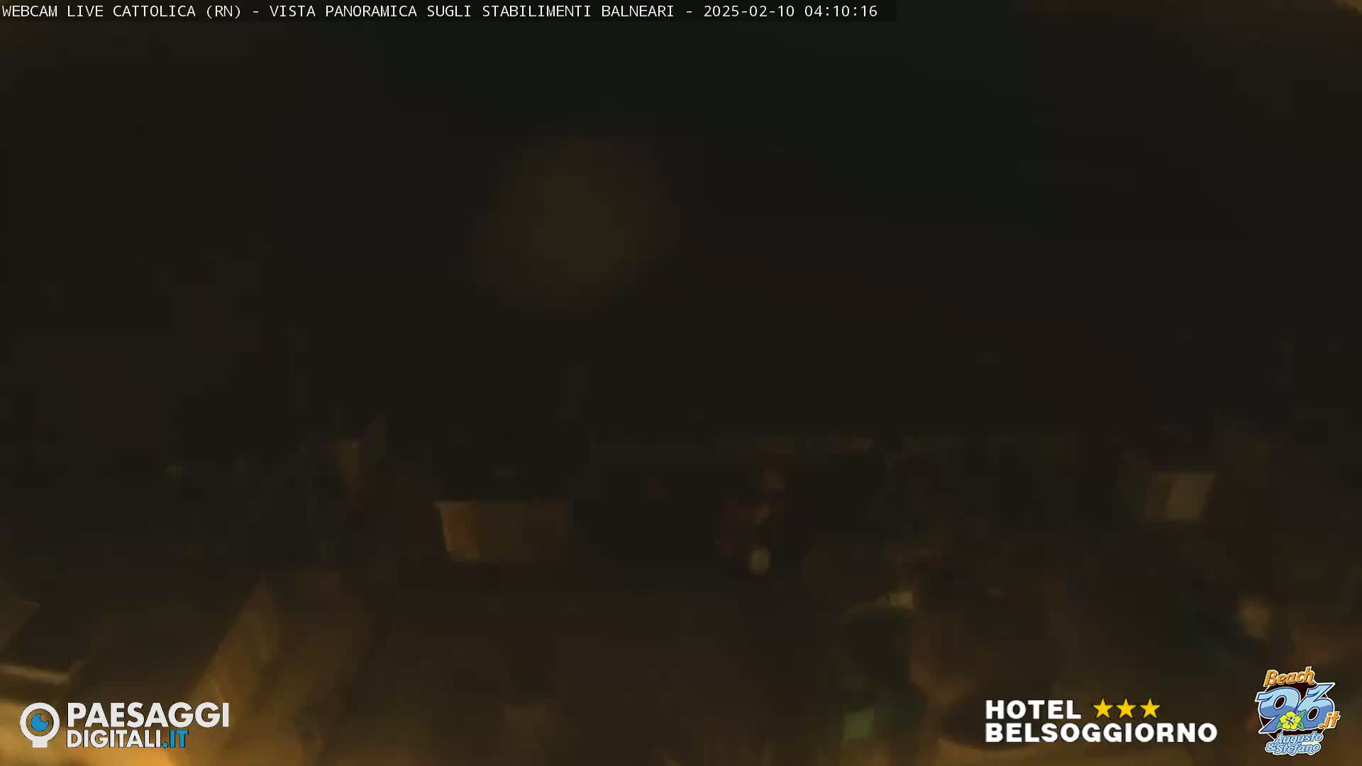 A dark, blurry nighttime image shows an indistinct outdoor scene.