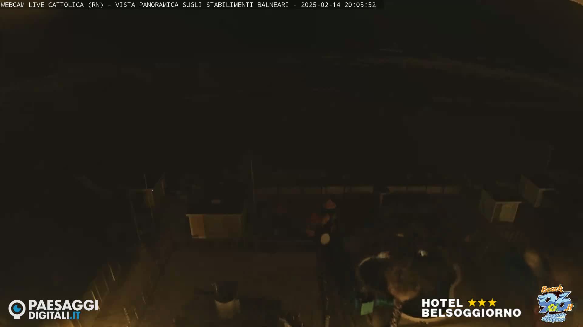 A nighttime, high-angle view of dimly lit beach structures.