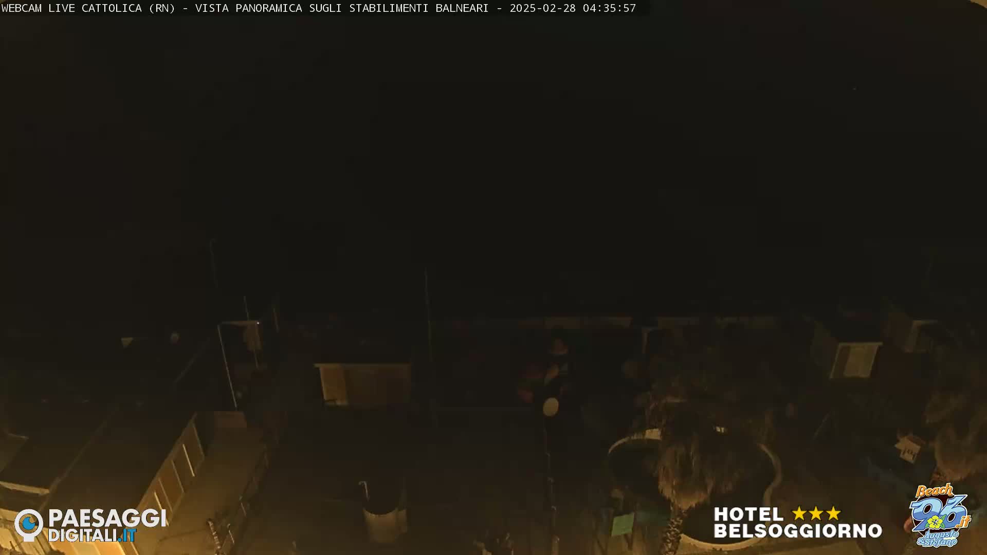 A nighttime, high-angle view of beachside buildings and structures.