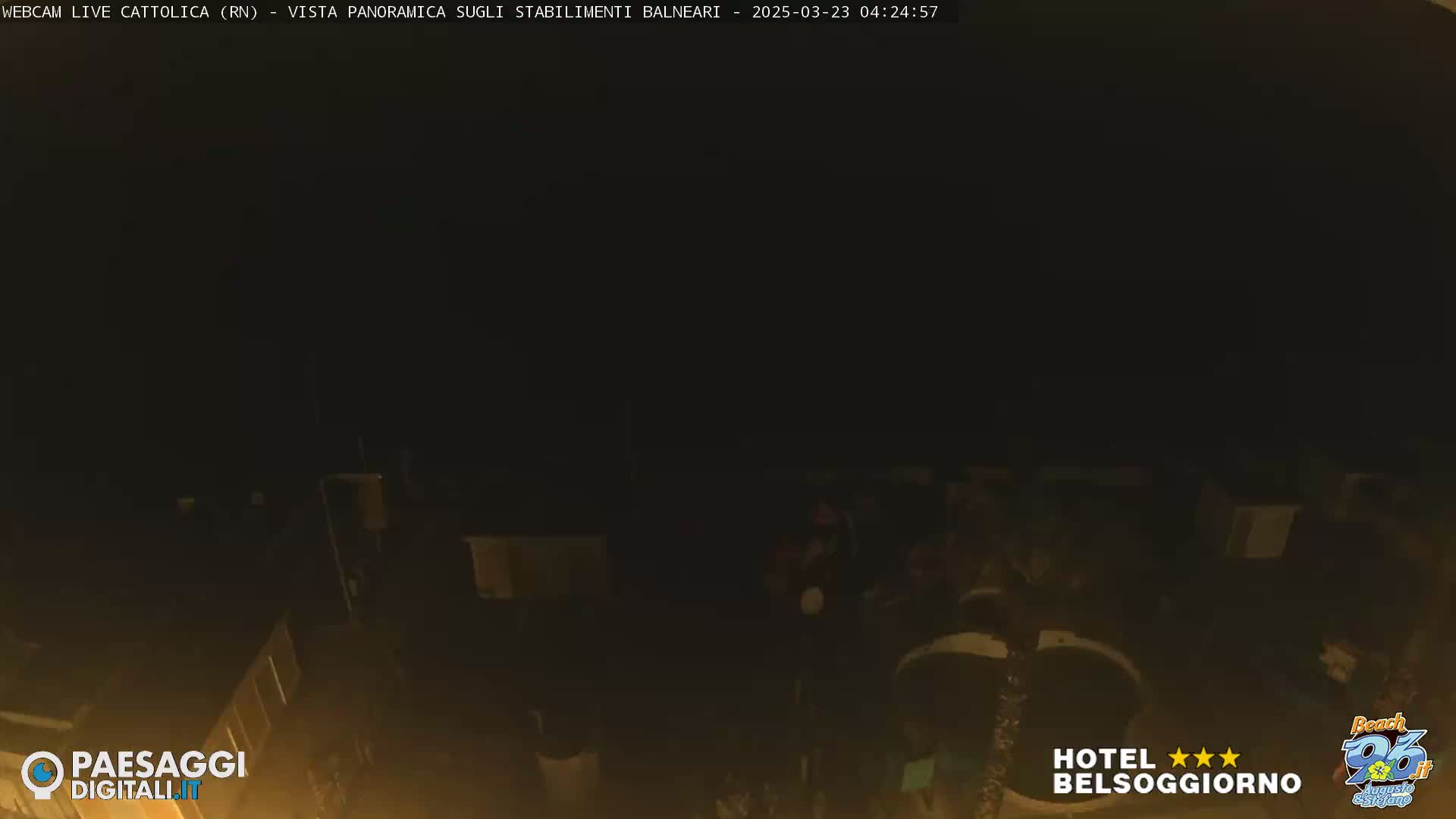 A nighttime, low-light view of what appears to be a dark outdoor area with some indistinct structures and objects.
