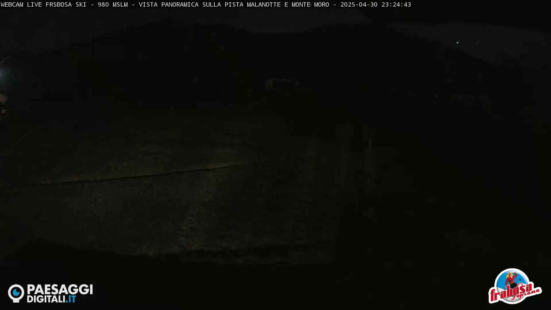 A dark, nighttime view of a mostly obscured landscape.