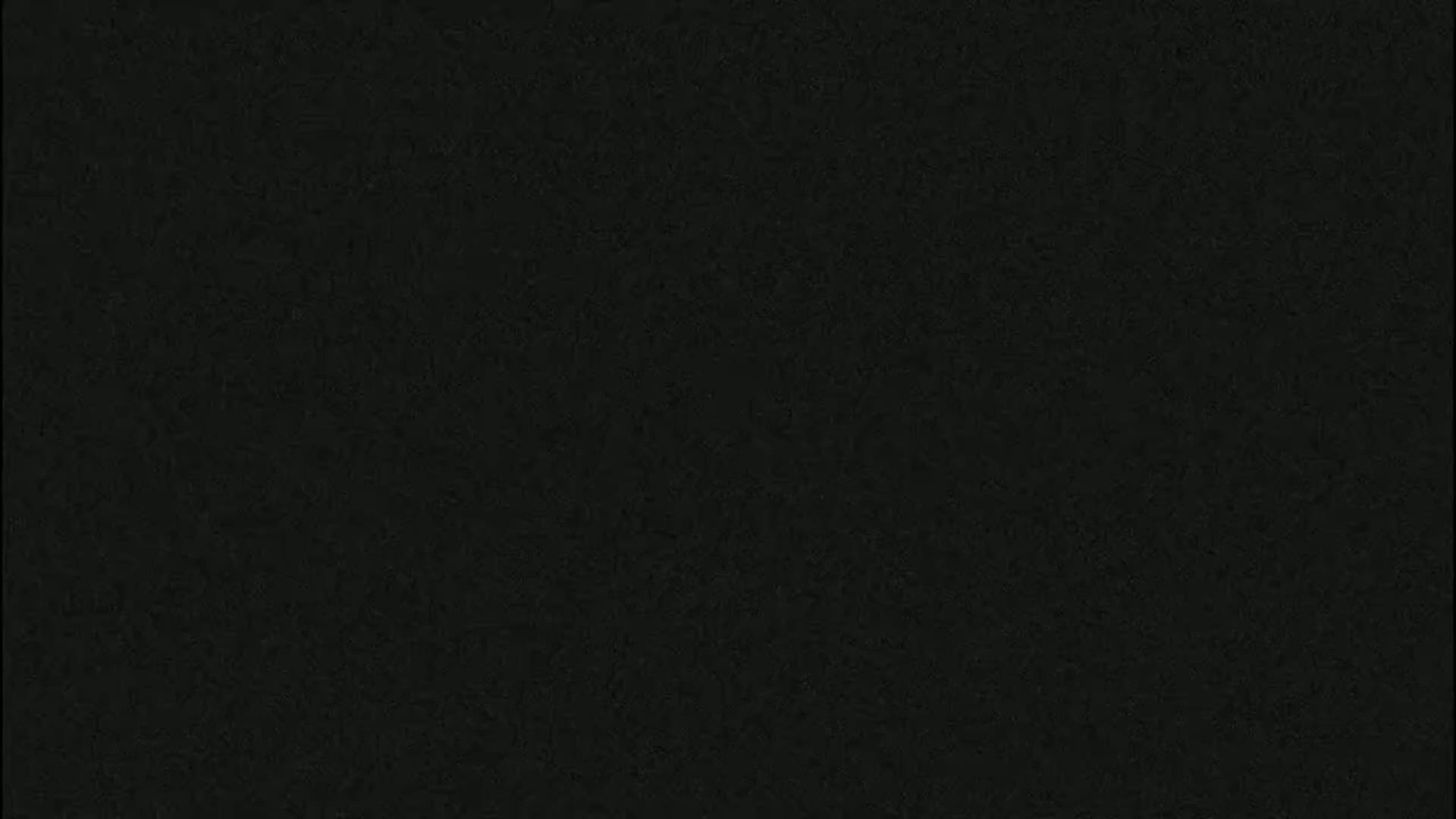 The image is a solid dark-gray or black textured surface.