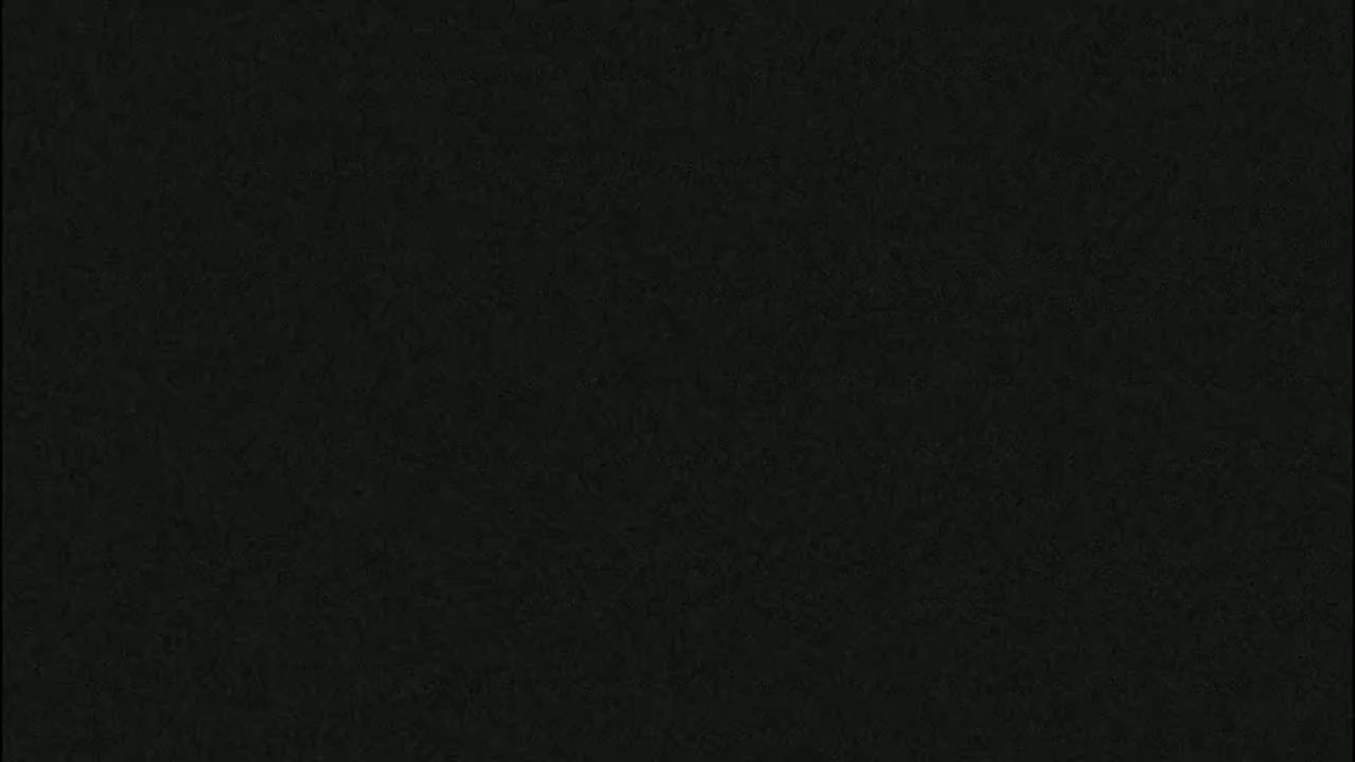 The image shows a dark gray or black textured surface.